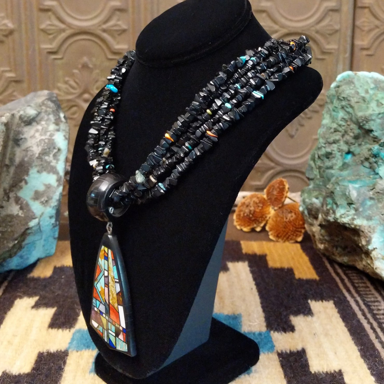 Sterling silver necklace featuring beaded strands and multistone inlay on the pendant.