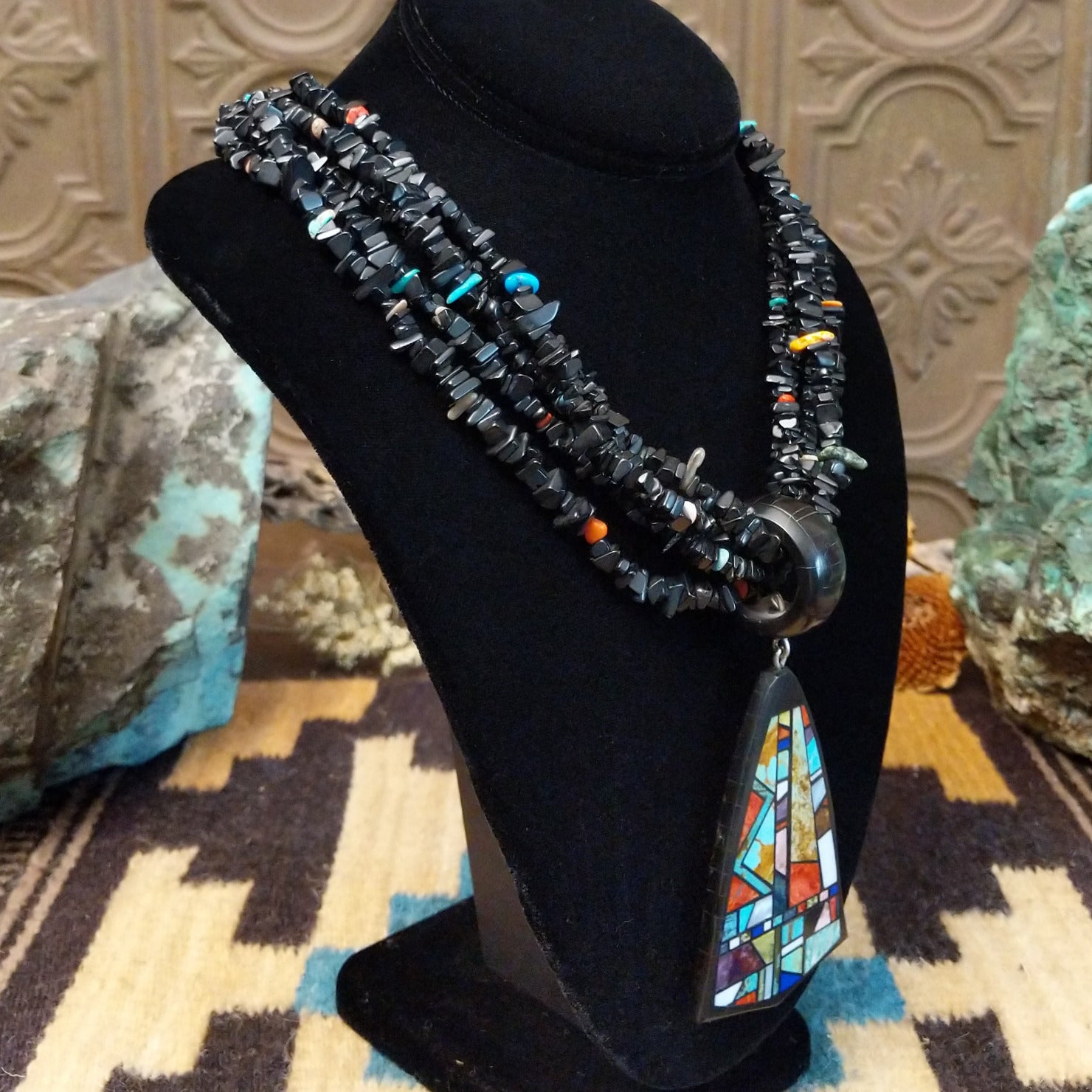 Sterling silver necklace featuring beaded strands and multistone inlay on the pendant.