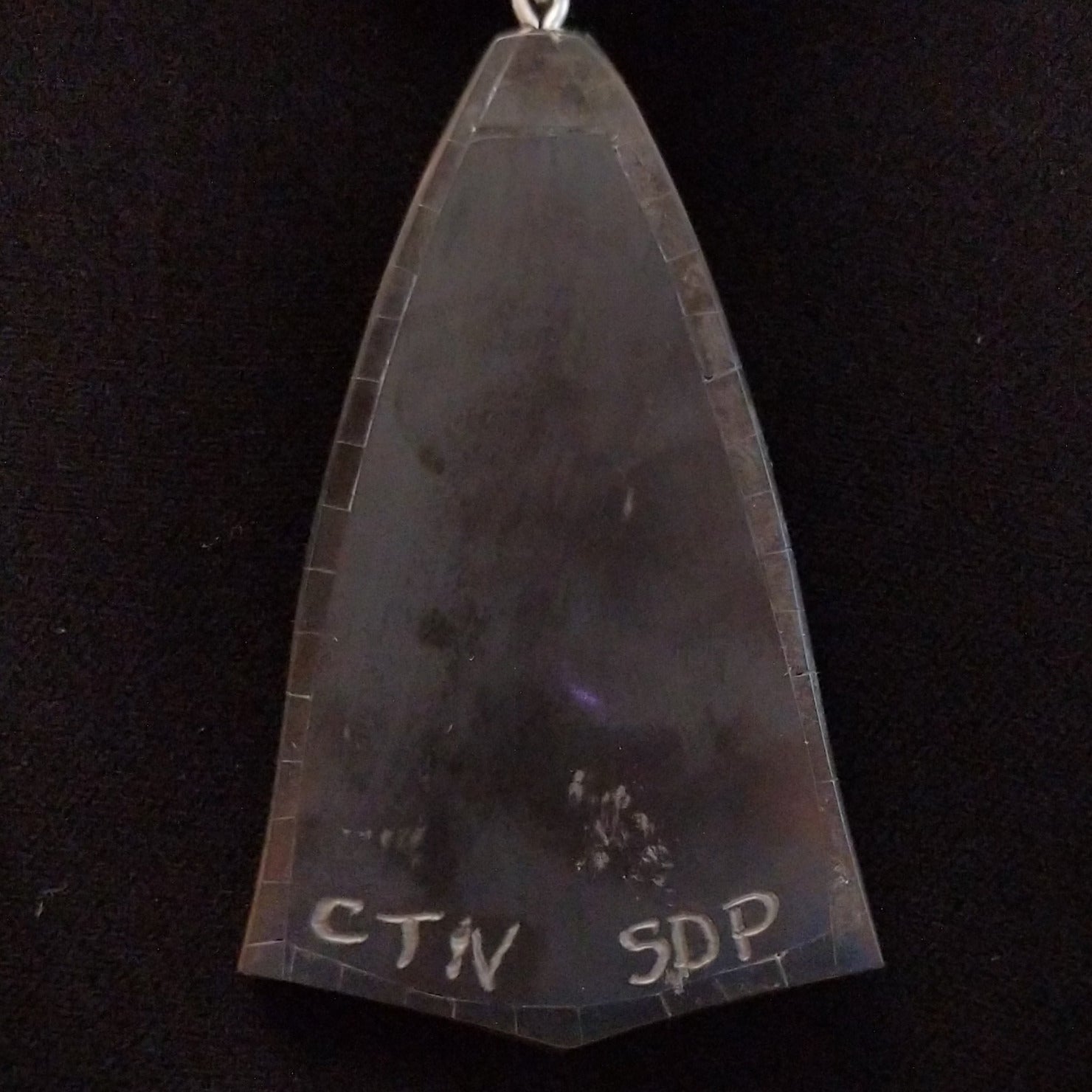 Close-up of the artisan's stamped signature.