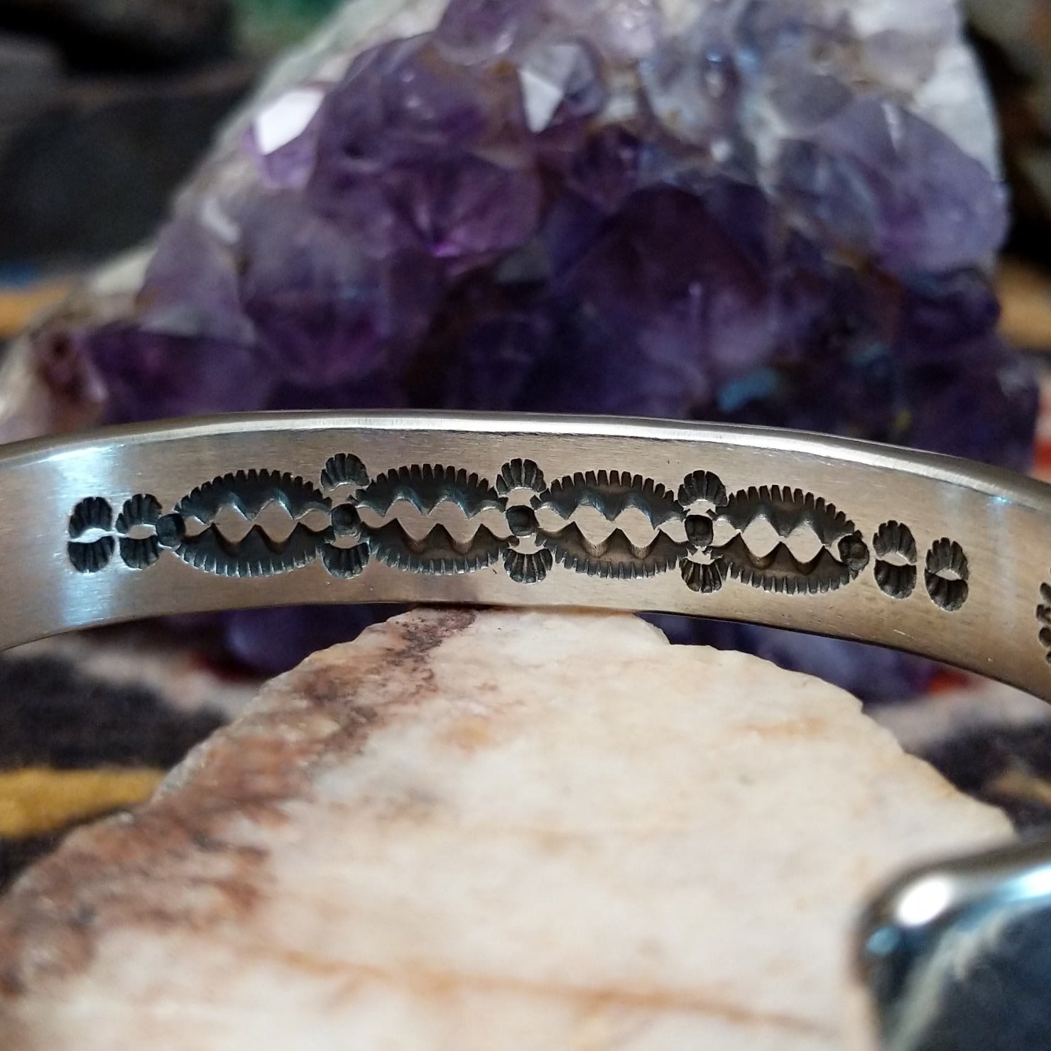 Detailed view of decorative stamp pattern along the inside of the cuff.