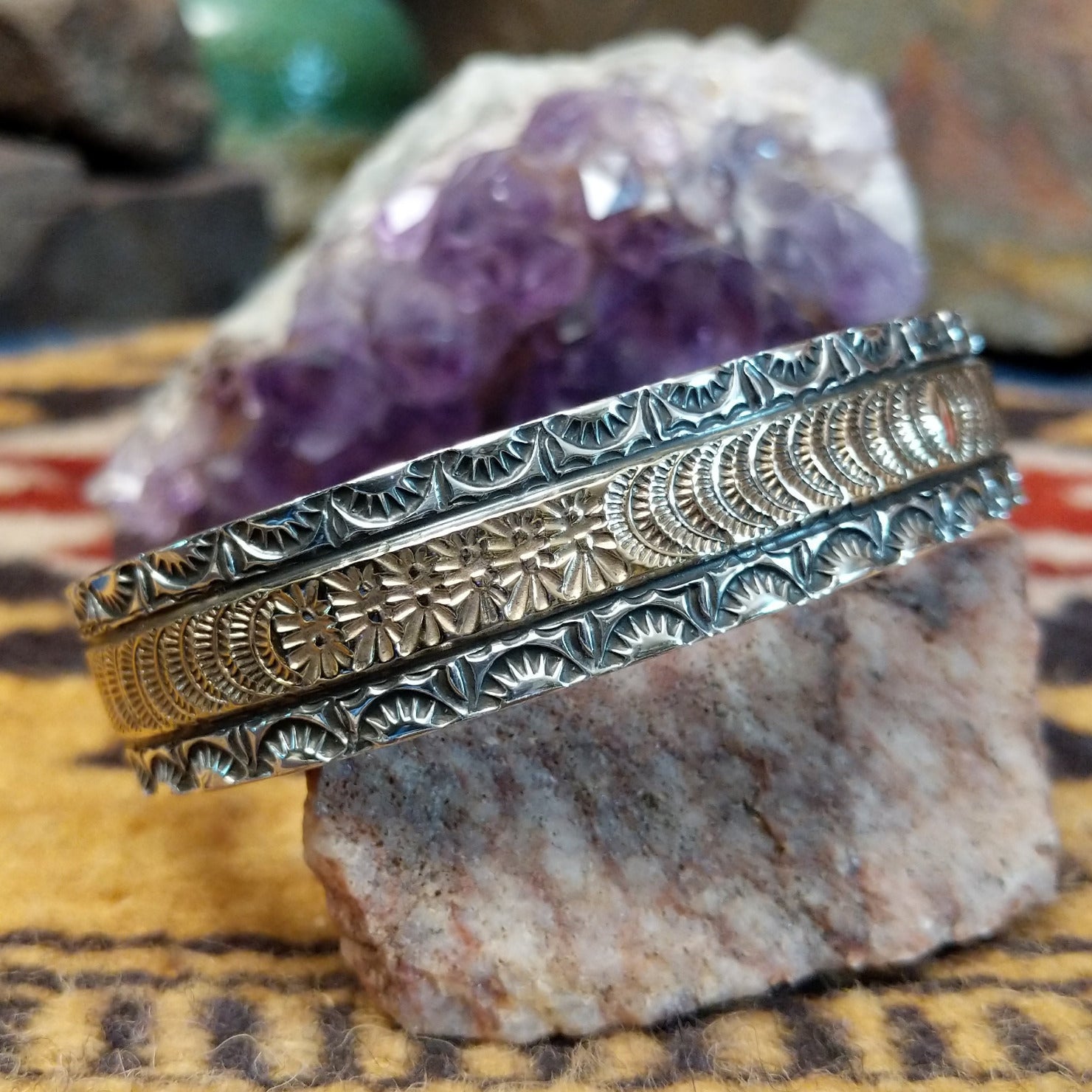 Sterling silver and 14k gold cuff by Marc Antia with sunbeam stampwork and floral accents.