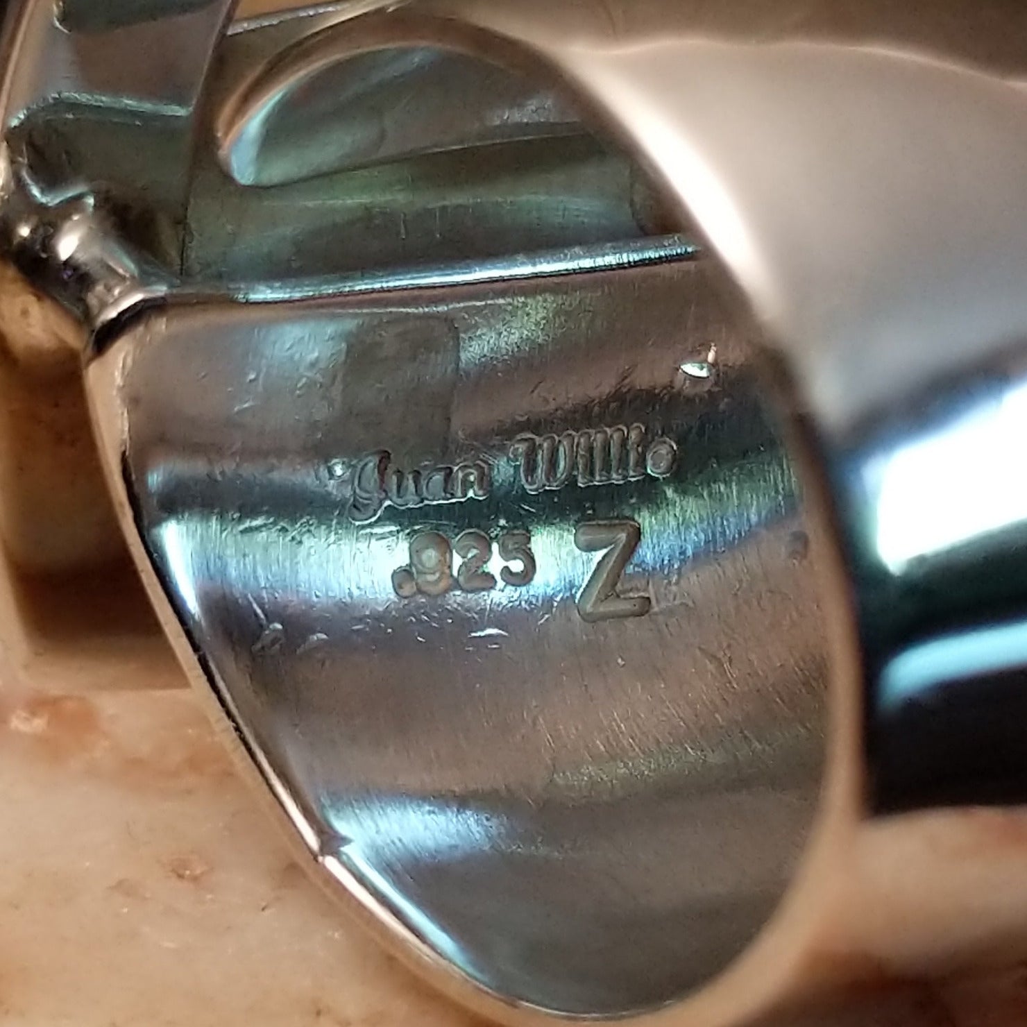 Close-up of the artisan's stamped signature.