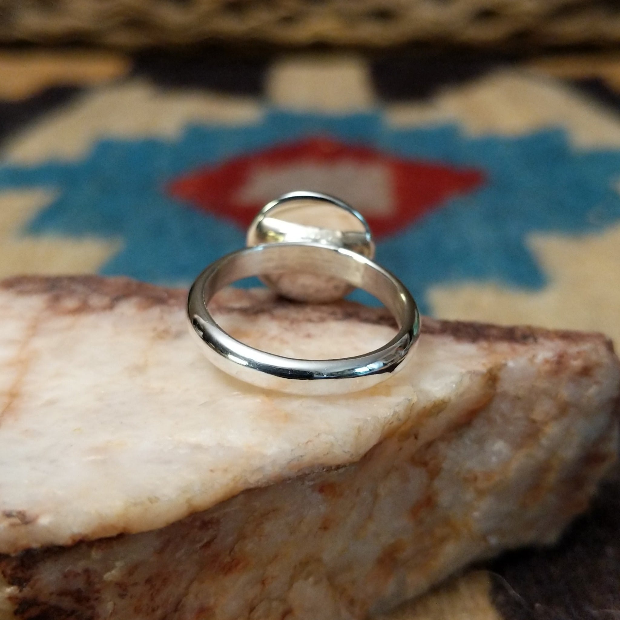 Silver dome shadowbox ring by Tricia Smith, featuring a handcrafted sterling silver dome with a dimensional shadowbox design and polished finish. Underside view.