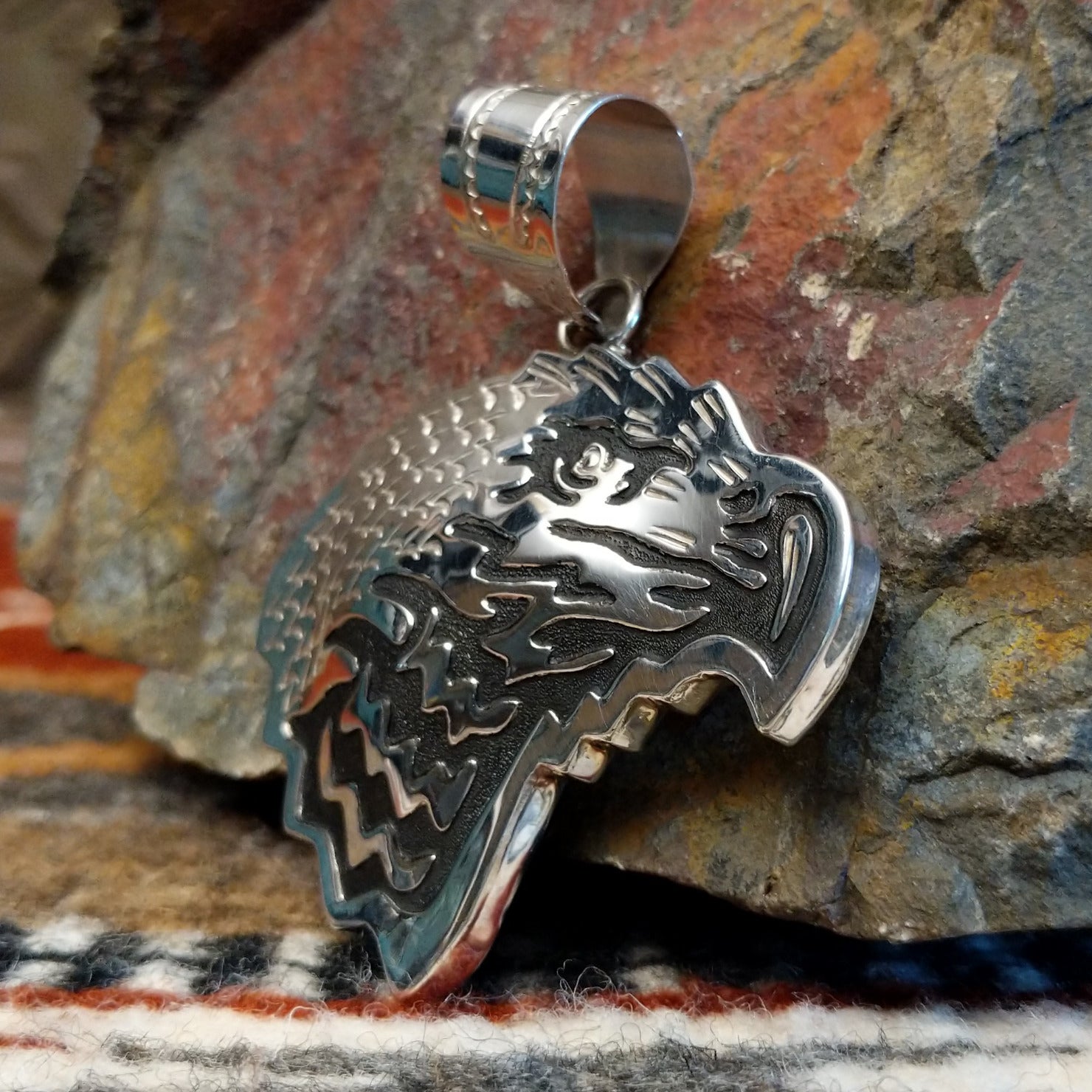Sterling silver eagle head pendant and polished finish.