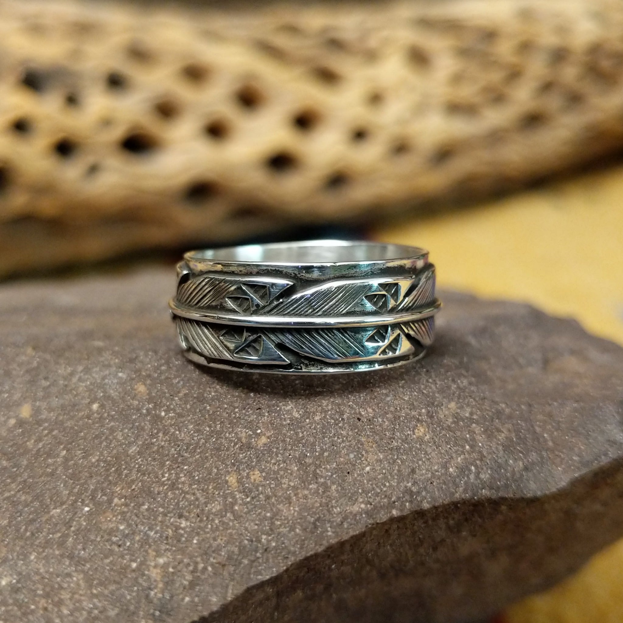 Silver feather ring by Raymond Coriz, featuring a detailed handcrafted feather design in polished sterling silver with traditional Southwestern-inspired craftsmanship.
