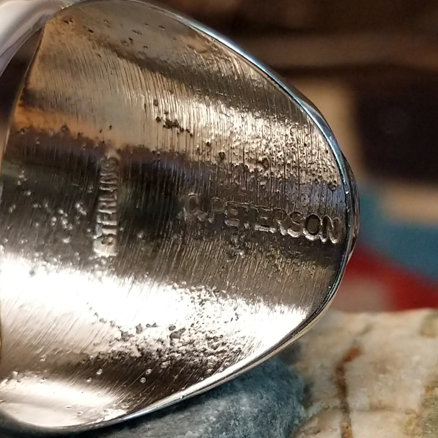 Close-up of the artisan's stamped signature.