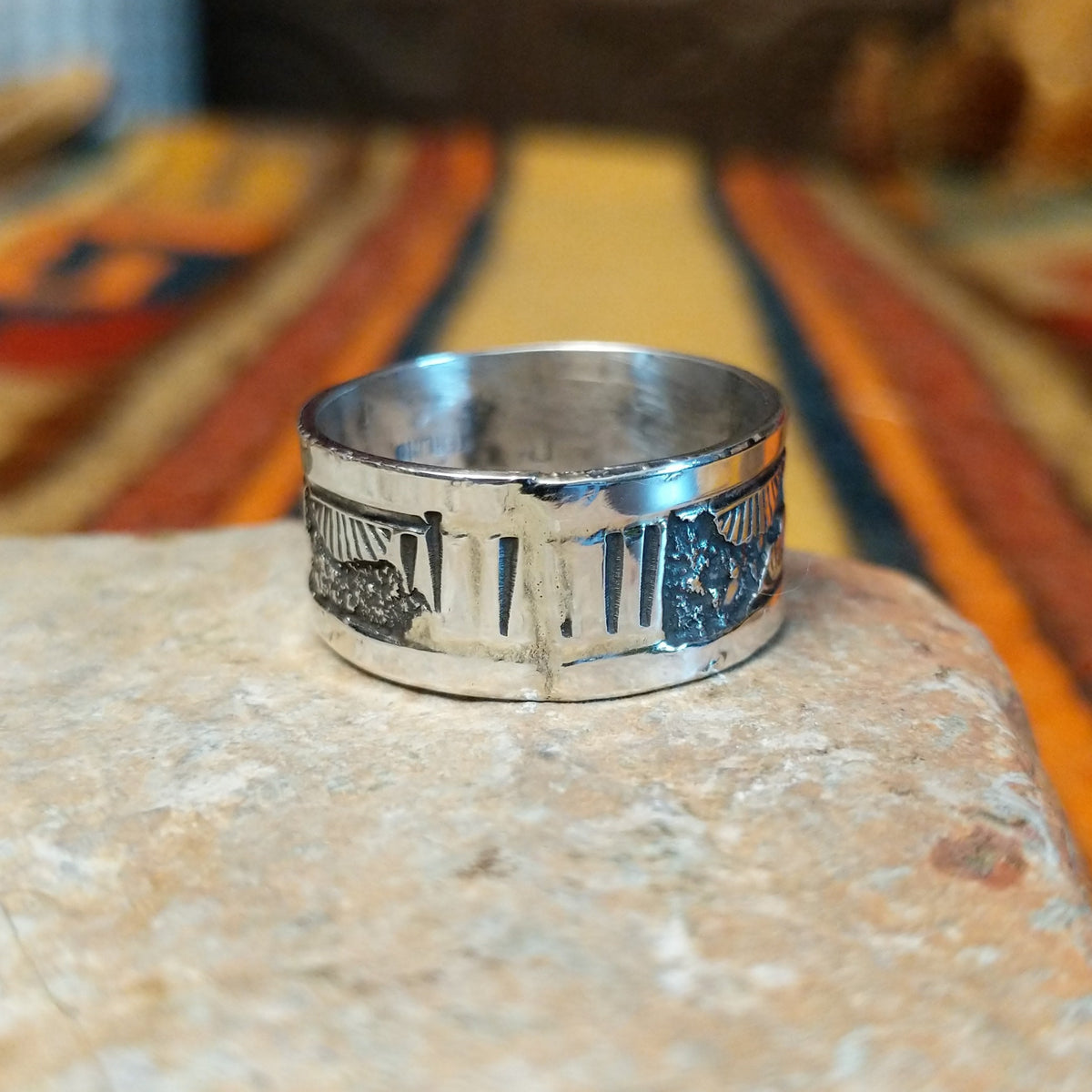 Silver Storyteller Ring by Elaine Becenti featuring a wide silver band with detailed landscape motifs, textured mountain designs, oxidized accents, and polished edges.