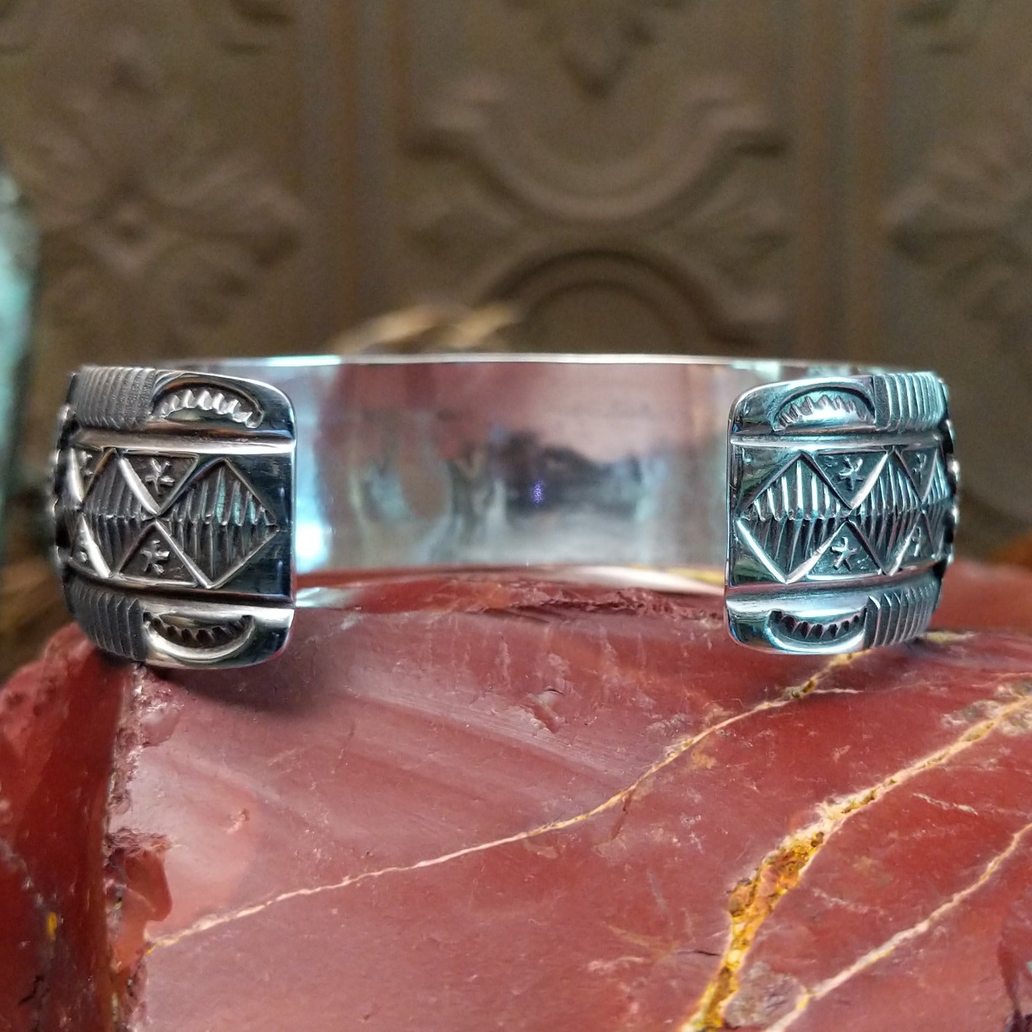 Sterling silver cuff with stamping and thunderbird motif.