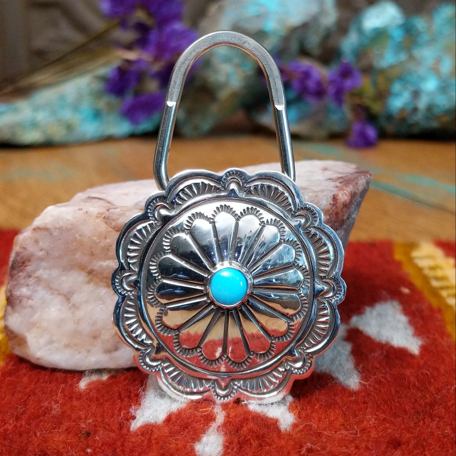 Sterling silver Arnold Blackgoat key hook with concho-style floral design and centered turquoise stone.