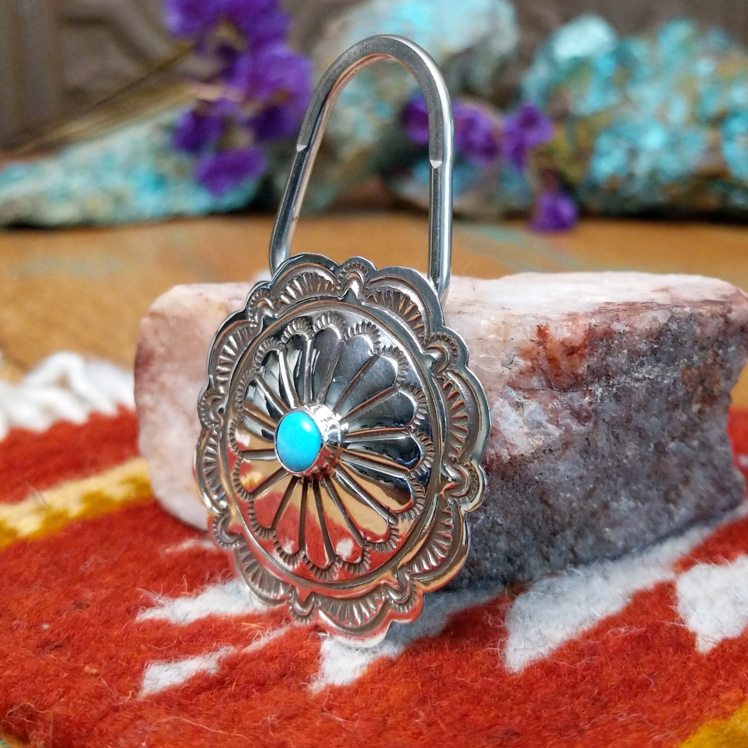 Sterling silver Arnold Blackgoat key hook with concho-style floral design and centered turquoise stone.