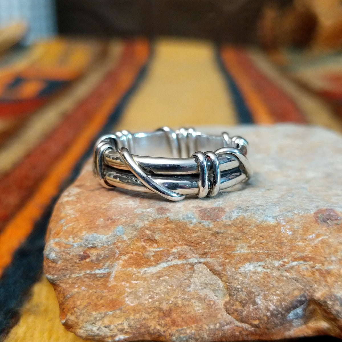 Silver Wire Ring by Raymond Coriz featuring layered sterling silver bands with curved wire wraps, decorative coils, and a polished finish in a Native American Southwestern design.