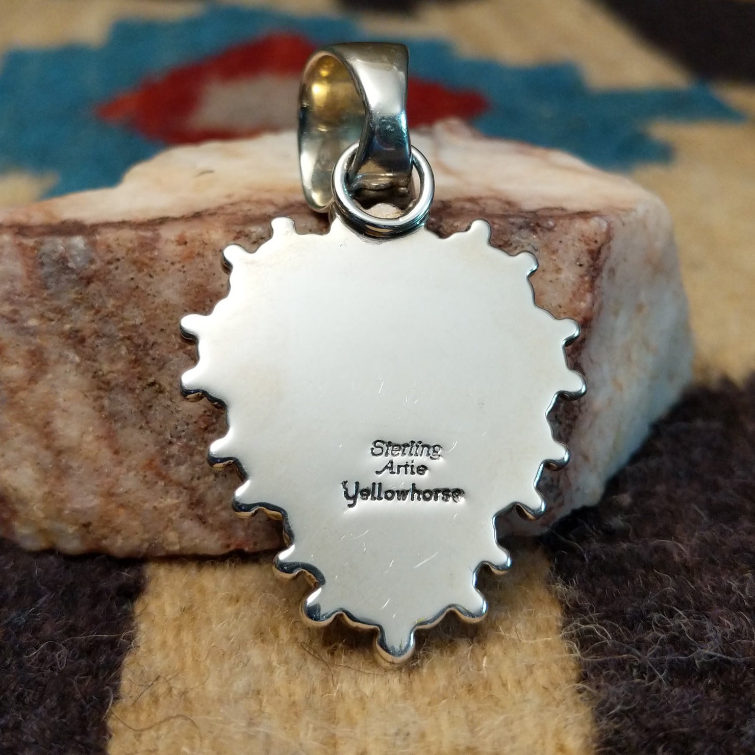 Sterling silver pendant featuring Sonoran Gold turquoise with green-blue tones and natural matrix, accented by dotted silver beadwork and handcrafted by Navajo artist Artie Yellowhorse. Back view with artisan and silver stamp.