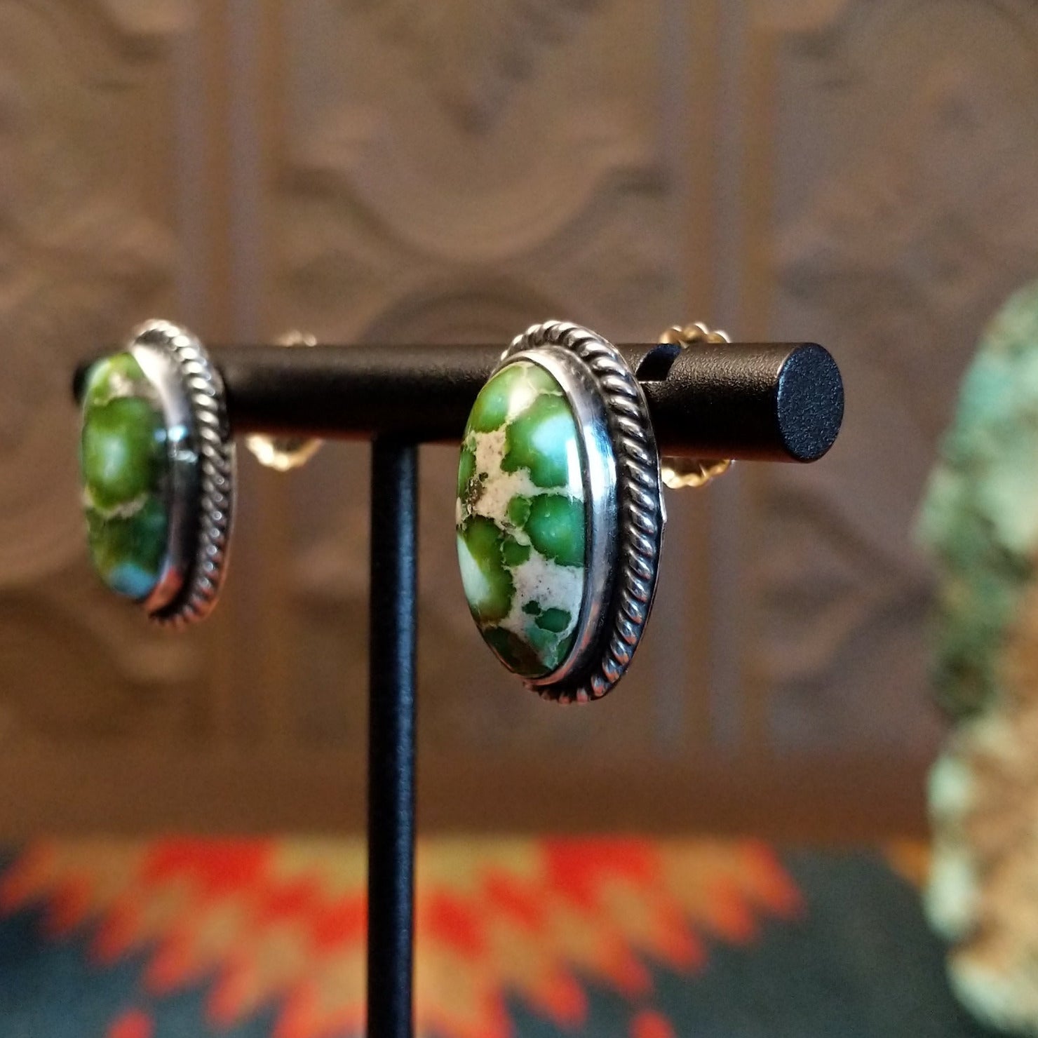 Sterling silver earrings with sonoran gold turquoise set in oval bezels, framed by twisted rope accents.