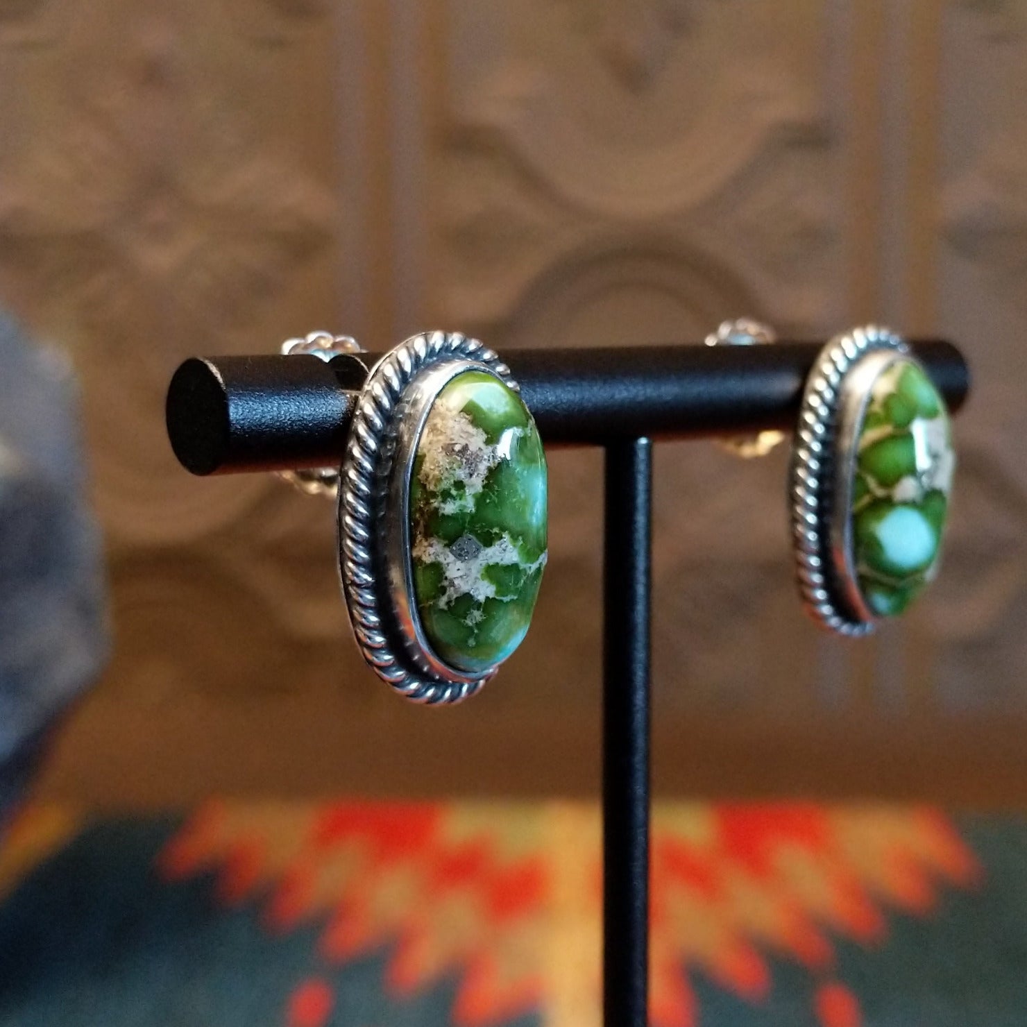 Sterling silver earrings with sonoran gold turquoise set in oval bezels, framed by twisted rope accents.