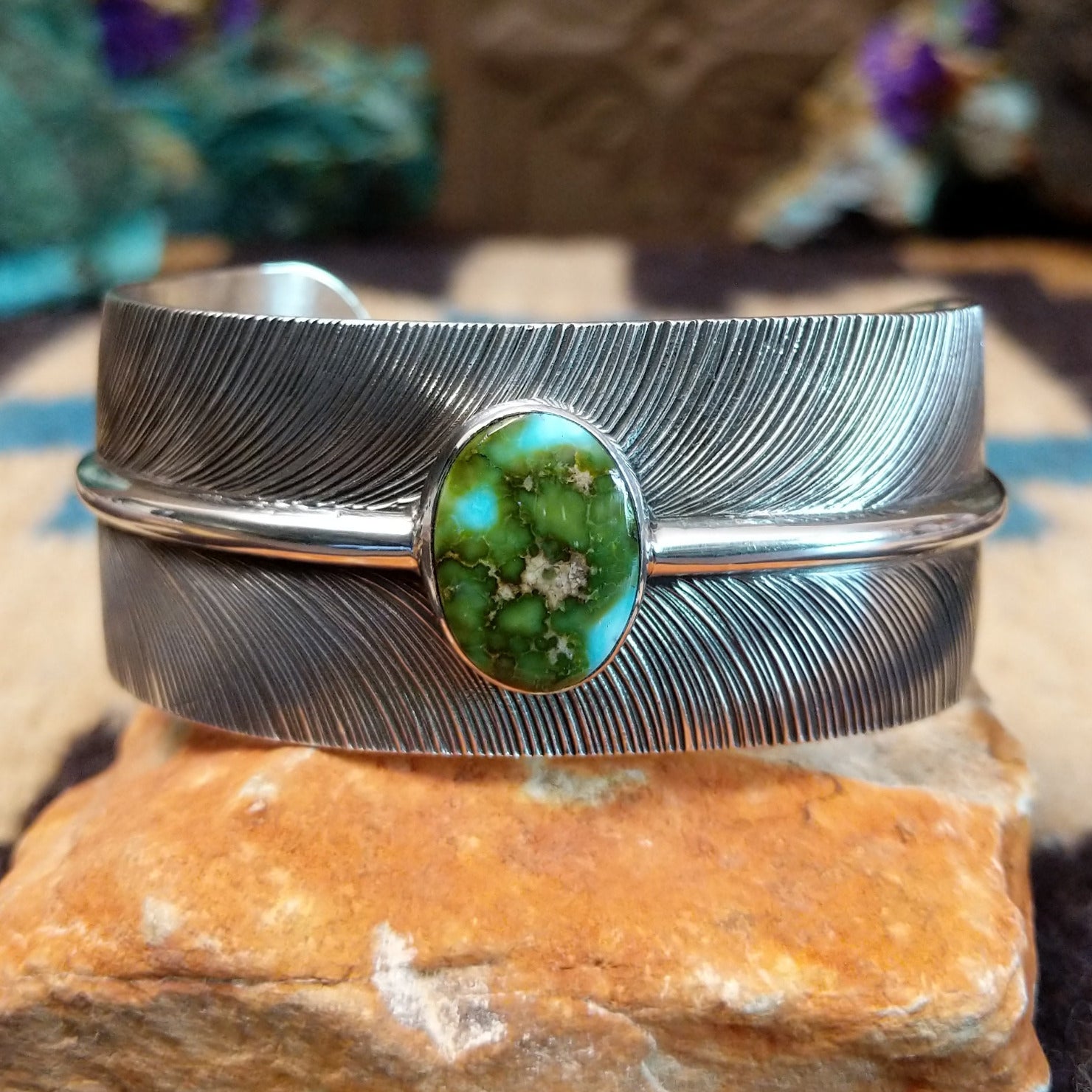 Sonoran Gold turquoise feather cuff by Angela Martin, featuring a vibrant turquoise stone, detailed feather design, and handcrafted Southwestern-inspired metalwork.