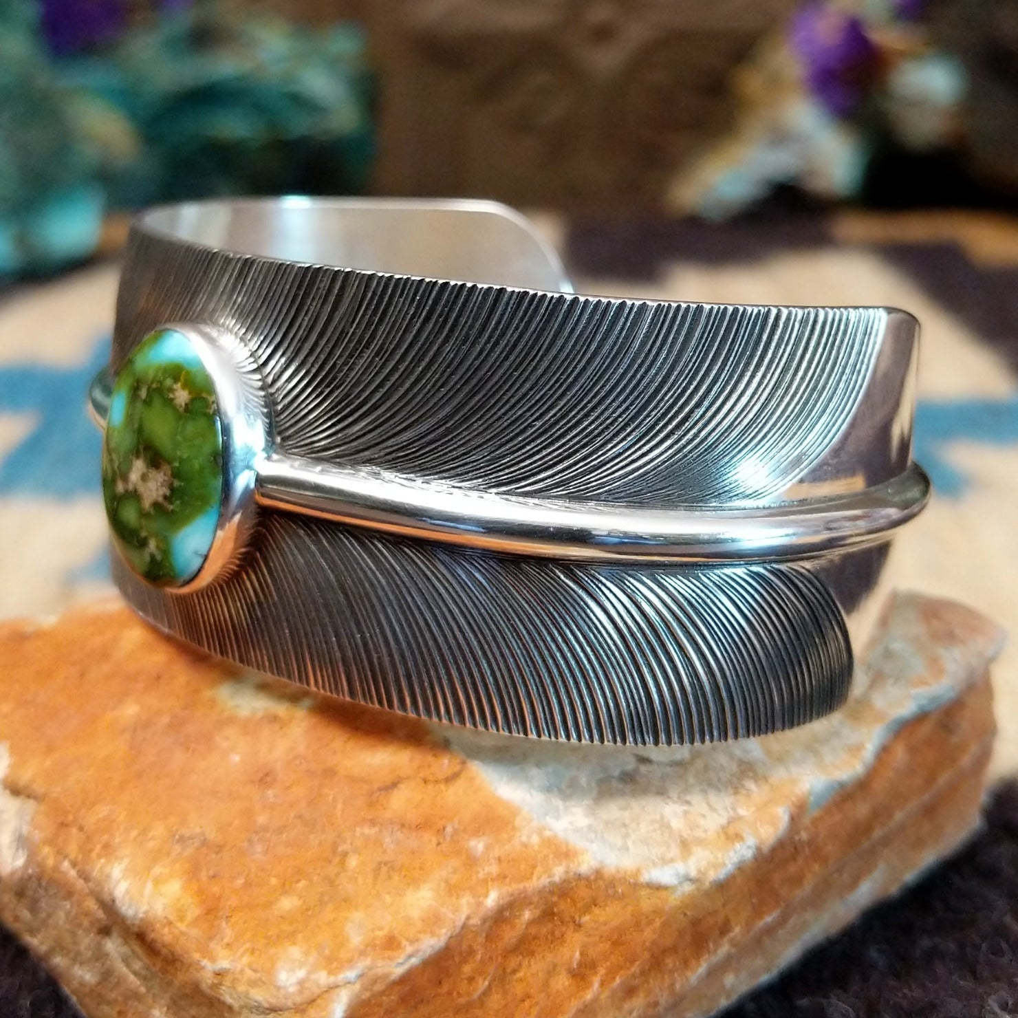 Sonoran Gold turquoise feather cuff by Angela Martin, featuring a vibrant turquoise stone, detailed feather design, and handcrafted Southwestern-inspired metalwork. Side view.