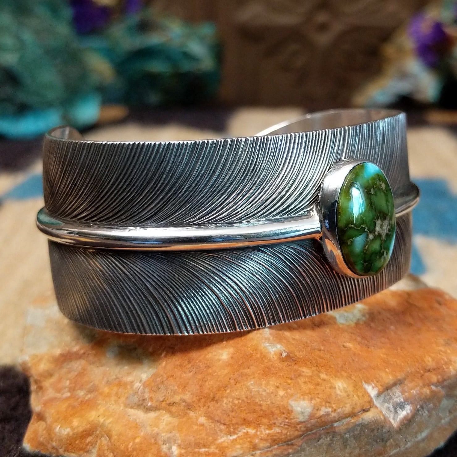 Sonoran Gold turquoise feather cuff by Angela Martin, featuring a vibrant turquoise stone, detailed feather design, and handcrafted Southwestern-inspired metalwork. Side view.