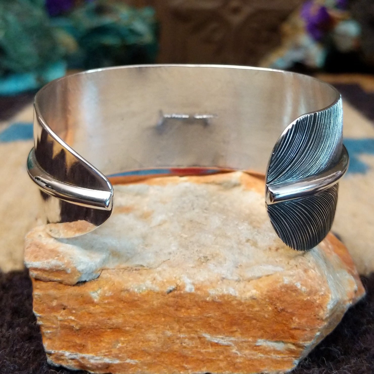 Sonoran Gold turquoise feather cuff by Angela Martin, featuring a vibrant turquoise stone, detailed feather design, and handcrafted Southwestern-inspired metalwork. Underside view.