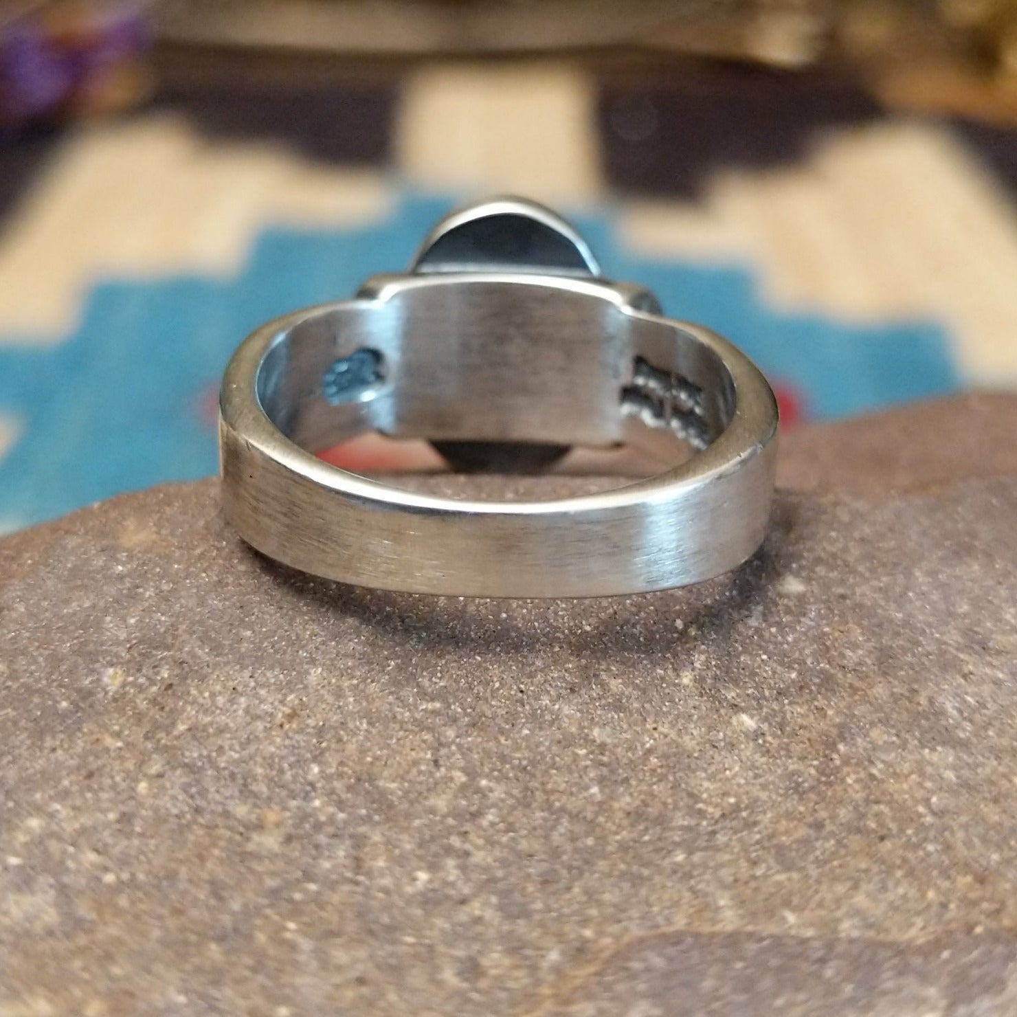 Sterling silver ring with Sonoran gold turquoise set in a raised, oval bezel and brushed finish.