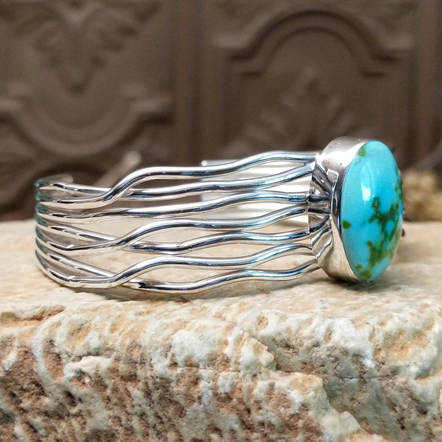Sterling silver cuff bracelet with Sonoran gold turquoise set in the oval bezel and seven strands of silver making up the band.