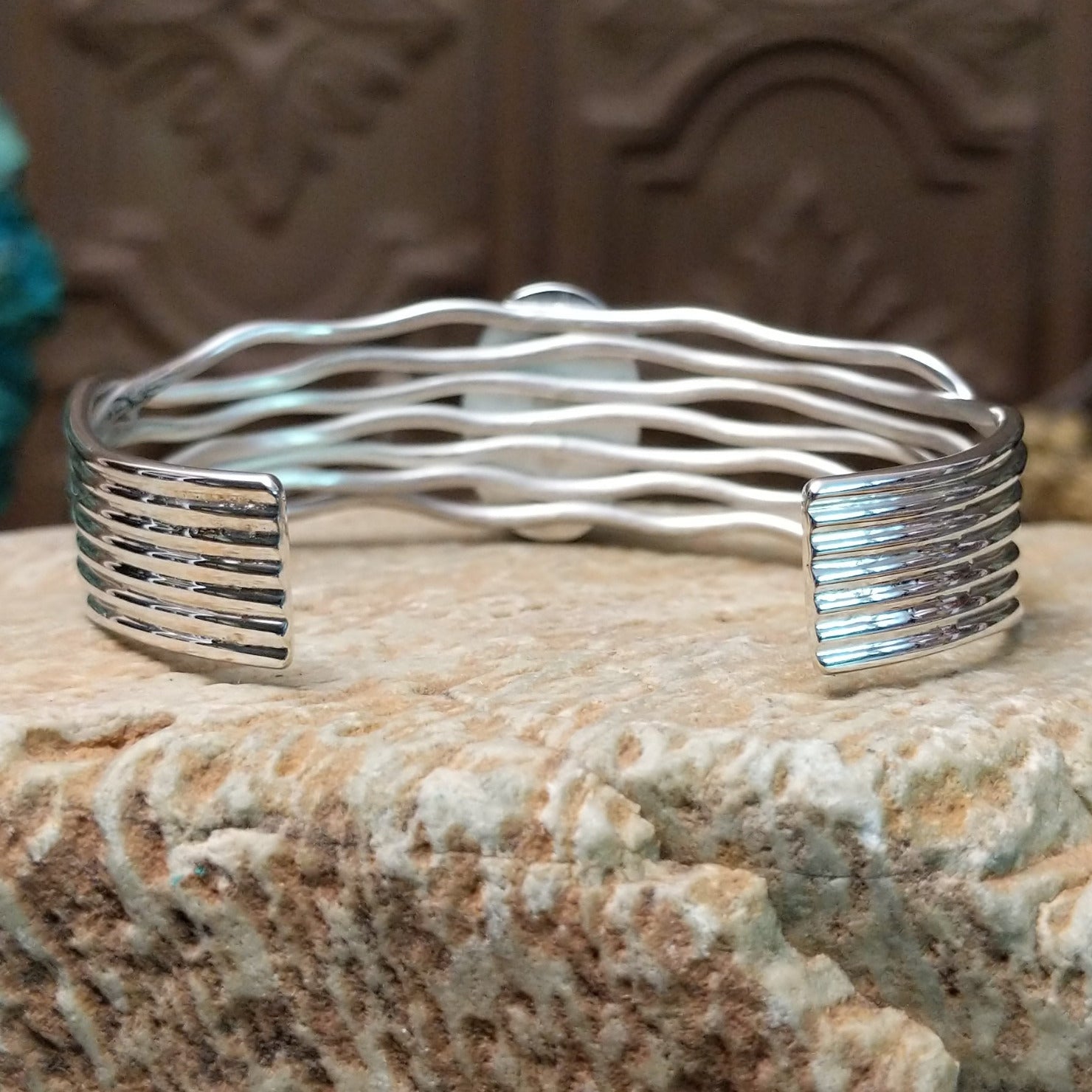 Sterling silver cuff bracelet with Sonoran gold turquoise set in the oval bezel and seven strands of silver making up the band.