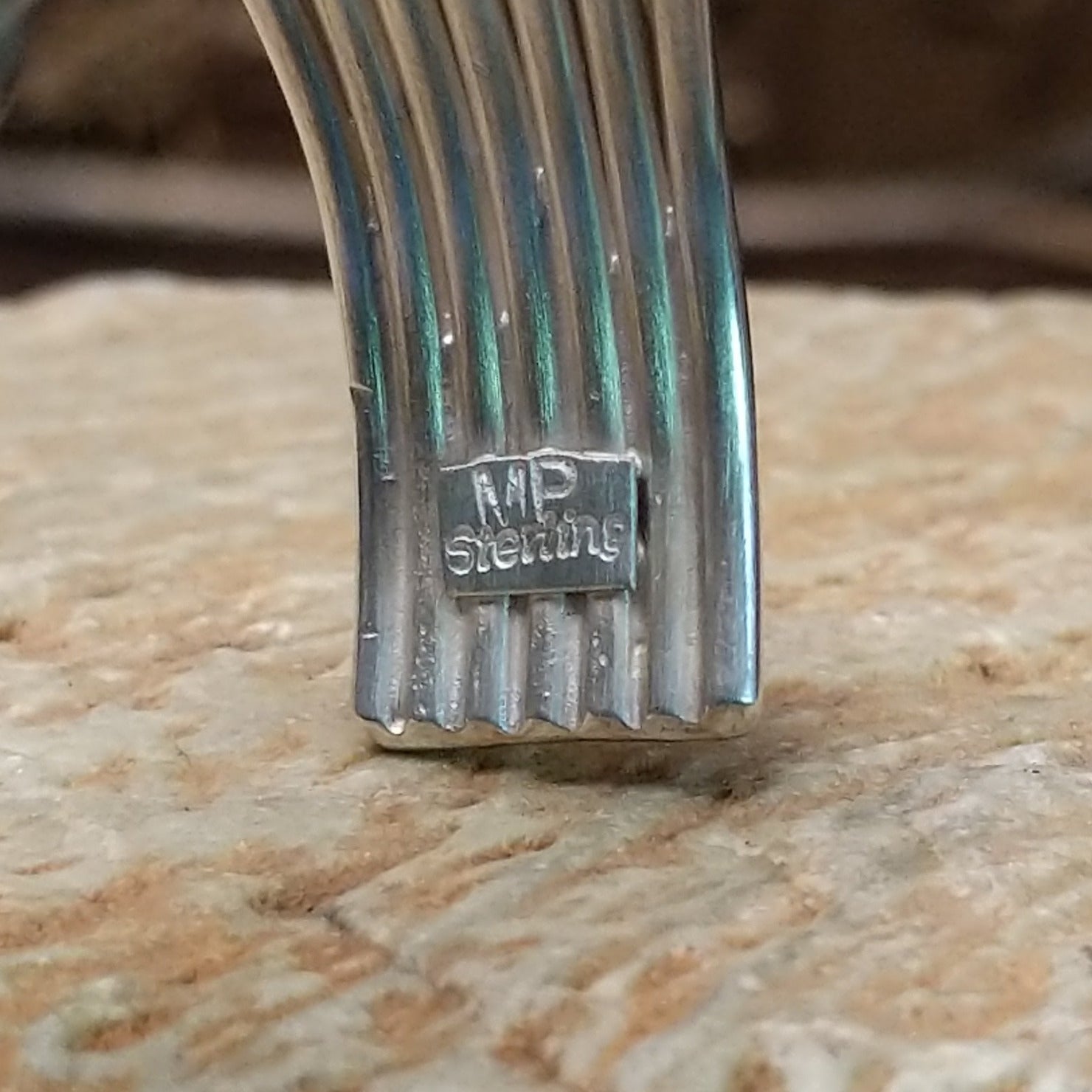 Close-up of the artisan's stamped signature.