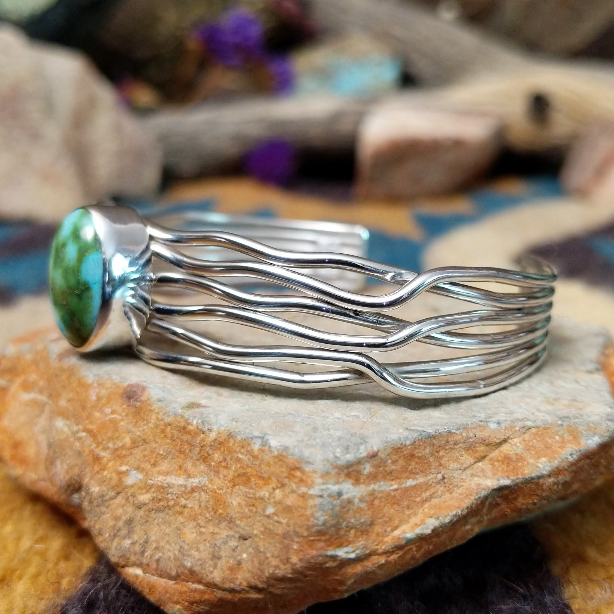 Handcrafted Navajo sterling silver five-strand cuff by Murphy Platero featuring an oval Sonoran Gold turquoise cabochon in a flowing open-wire design; side view.