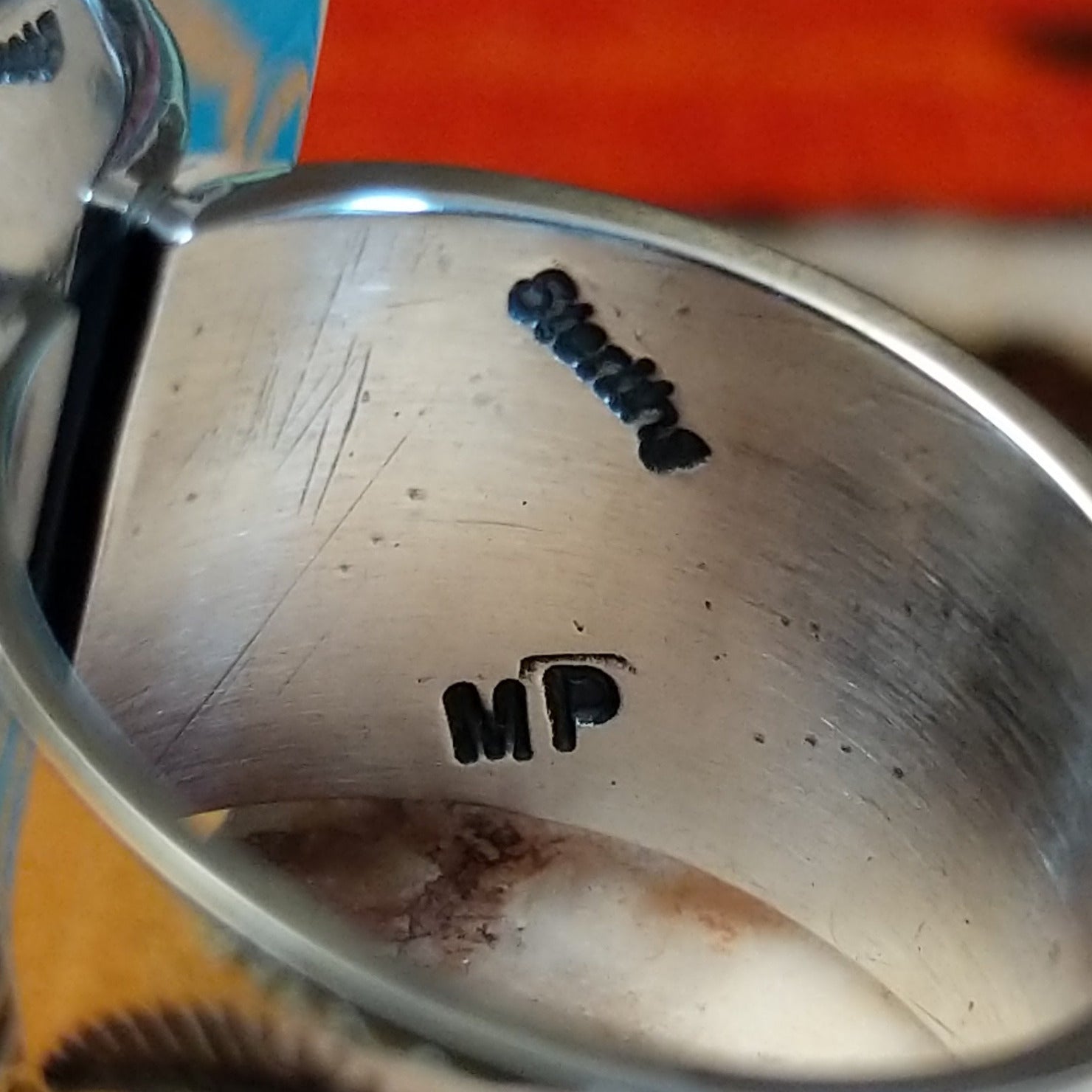 Close-up of the artisan's stamped signature.