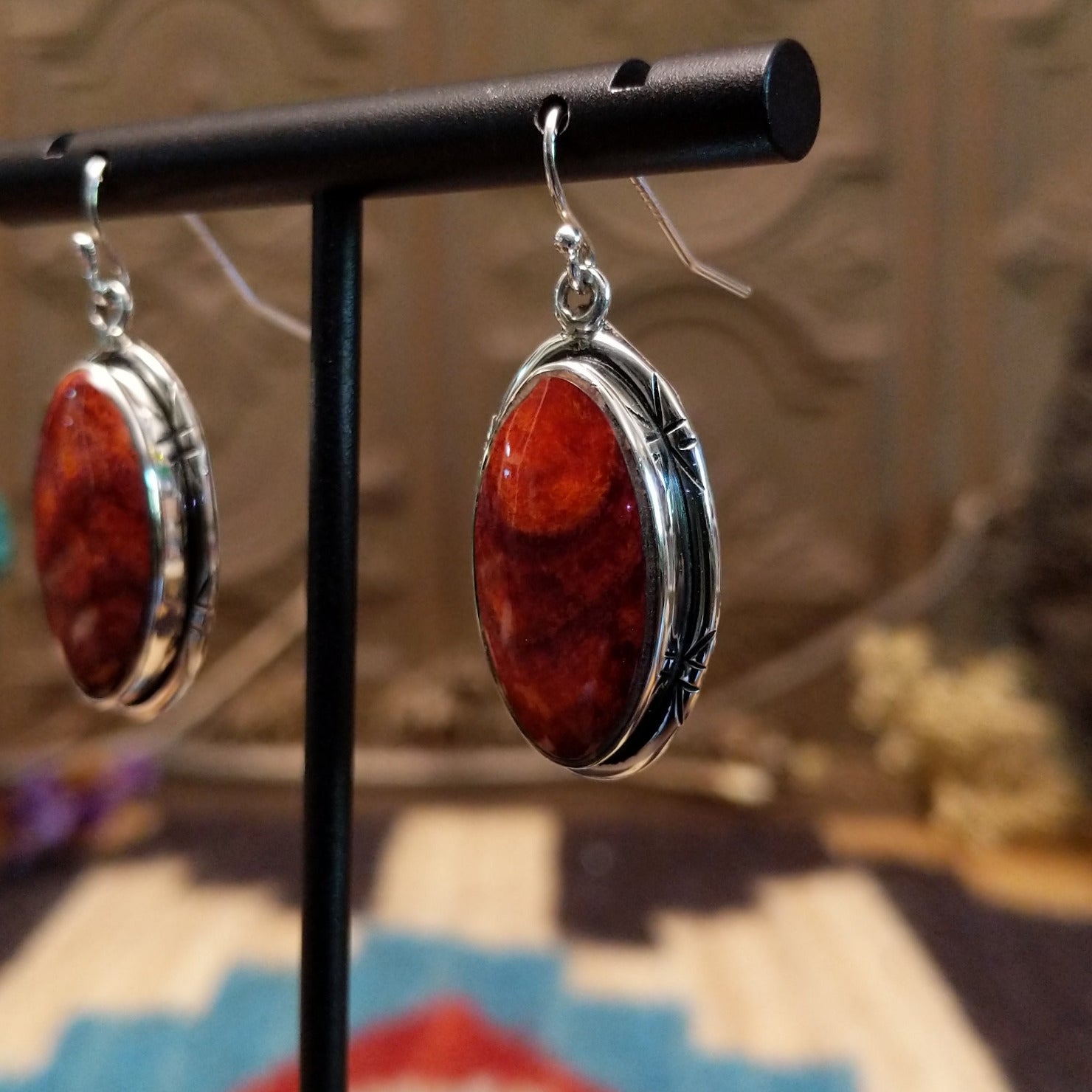 Sterling silver earrings with spiny oyster shell set in oval bezels, framed by incised settings.