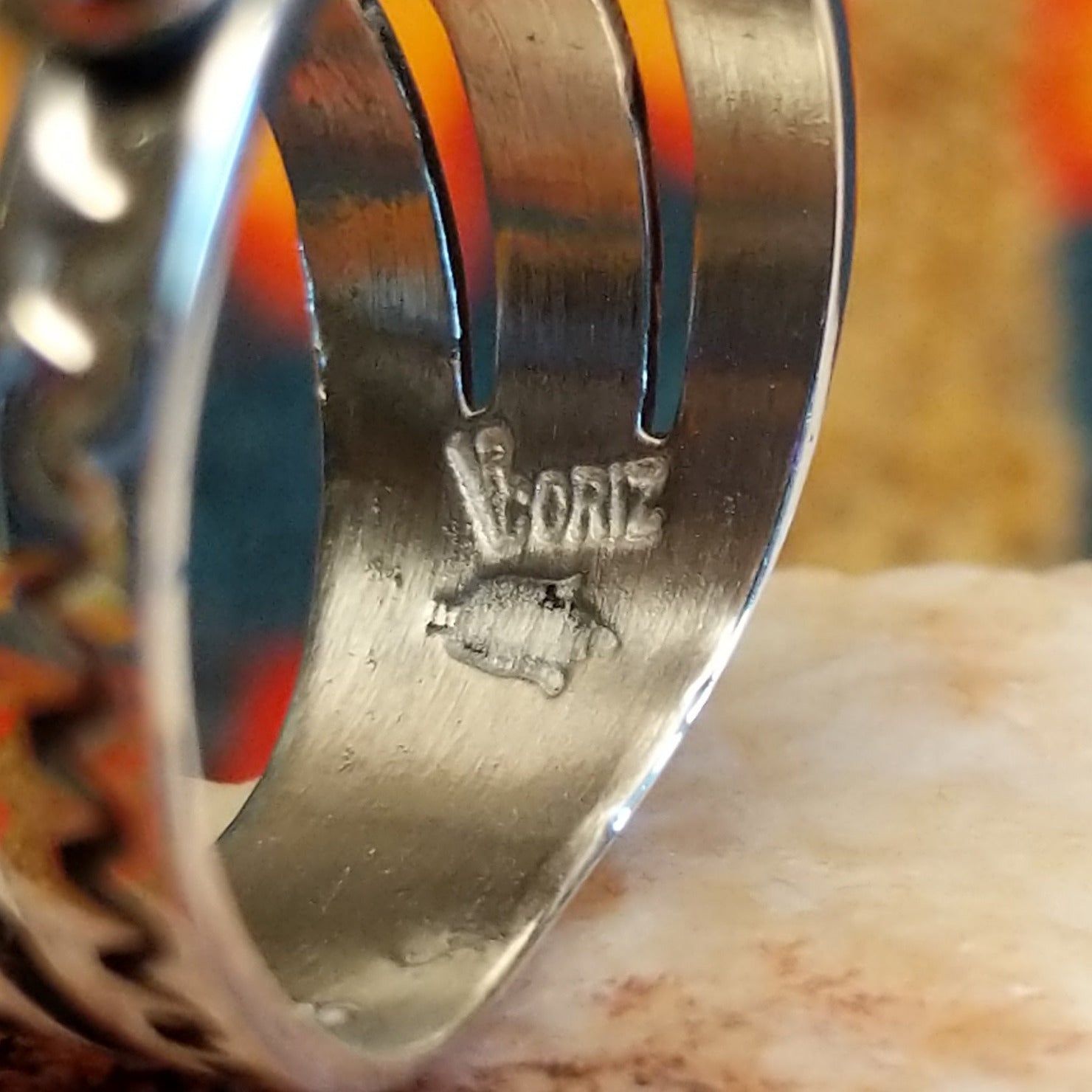 Close-up of the artisan's stamped signature.