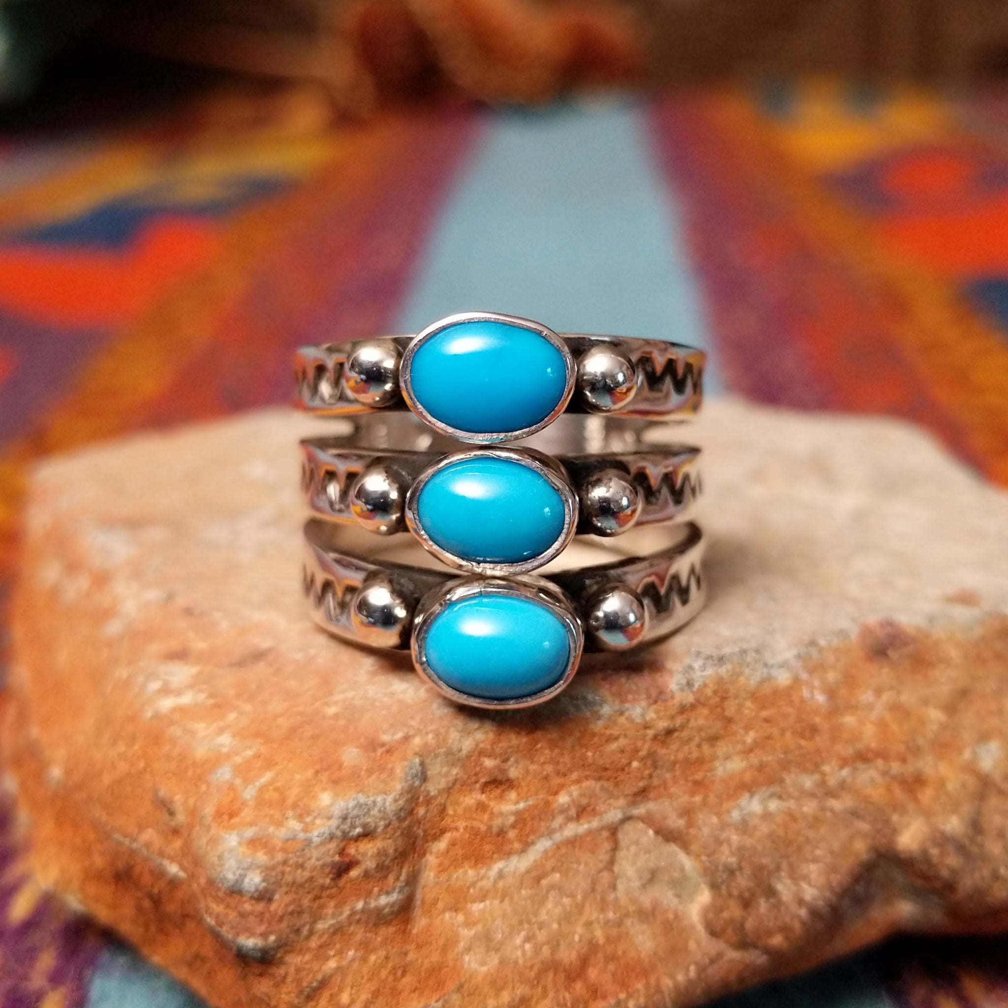 Stacked Turquoise Ring by Raymond Coriz featuring three oval turquoise stones set across three Sterling Silver bands with polished silver beads and hand-stamped detailing.