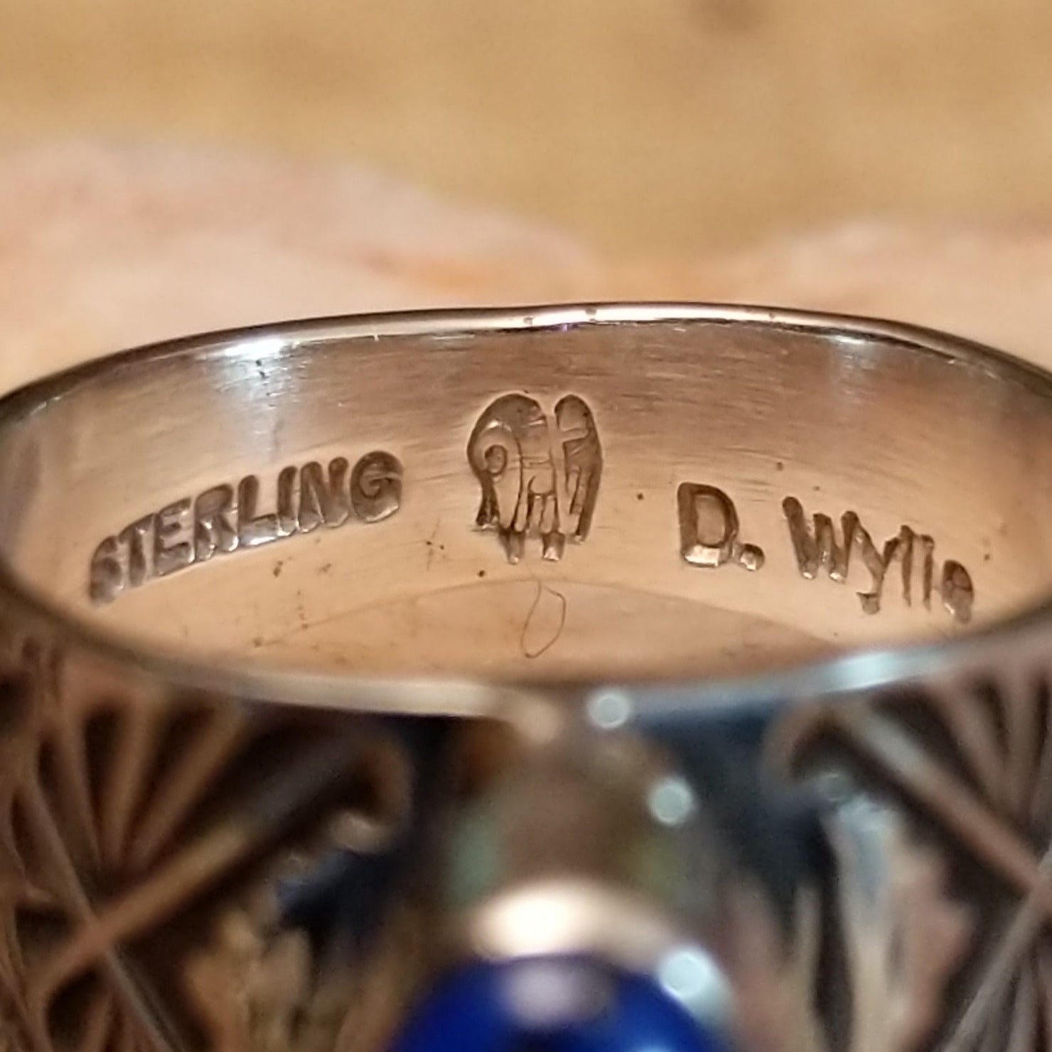Close-up of the artist's stamped signature.