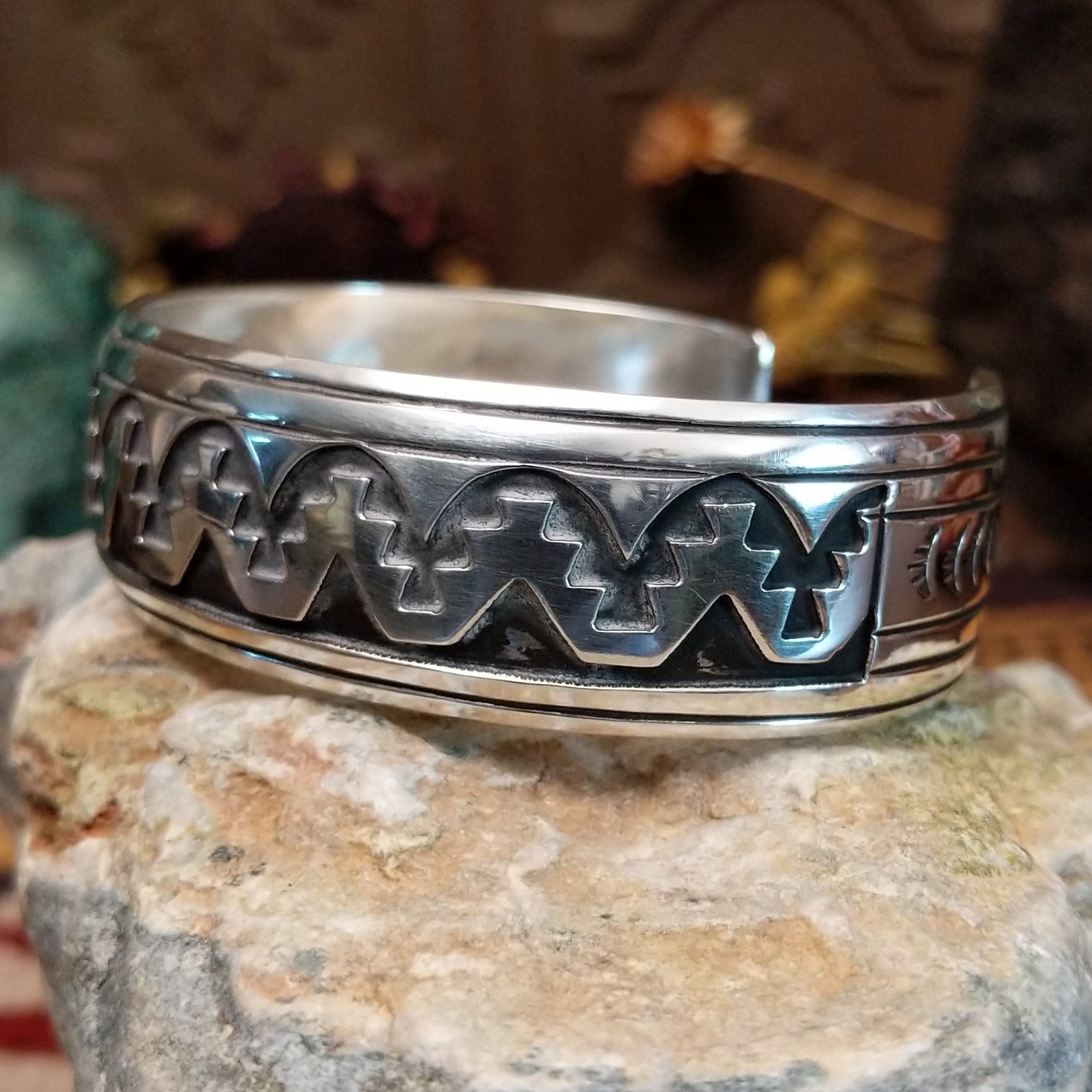 Sterling silver overlay cuff bracelet with repeating geometric motifs and oxidized detailing.