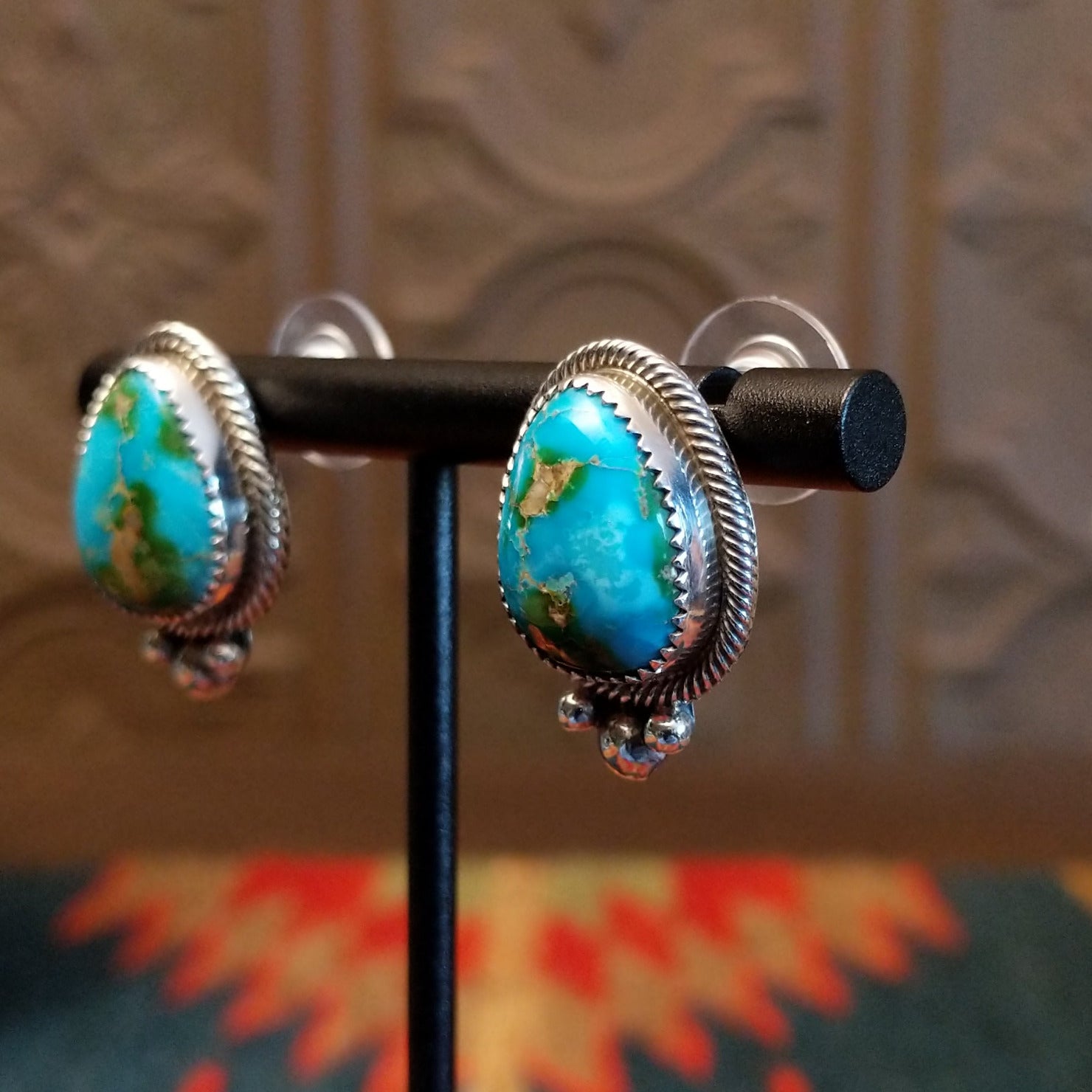 Sterling silver earrings with Sonoran Gold turquoise set in notched bezels, framed by dotted accents.
