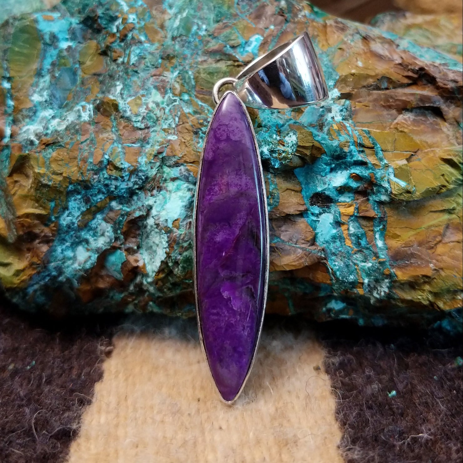Sterling silver pendant with sugilite set in a navette bezel.