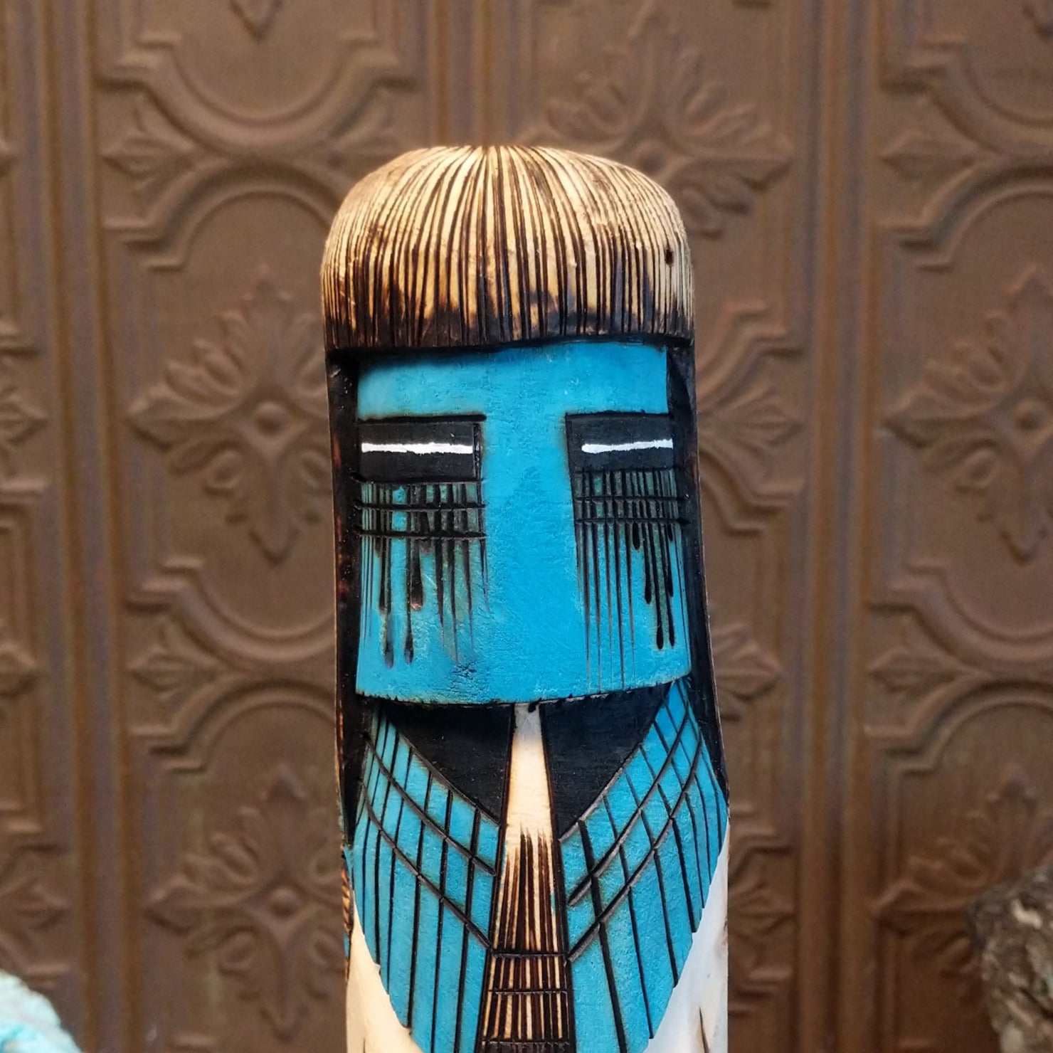 A close-up of the vibrant blue face with expression.