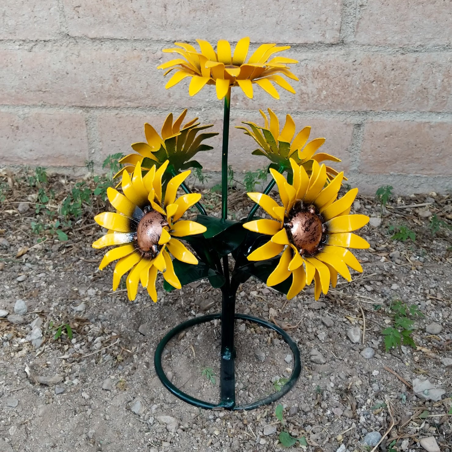 A metal sunflower bouquet with bright yellow petals and copper centers on black-green stems.