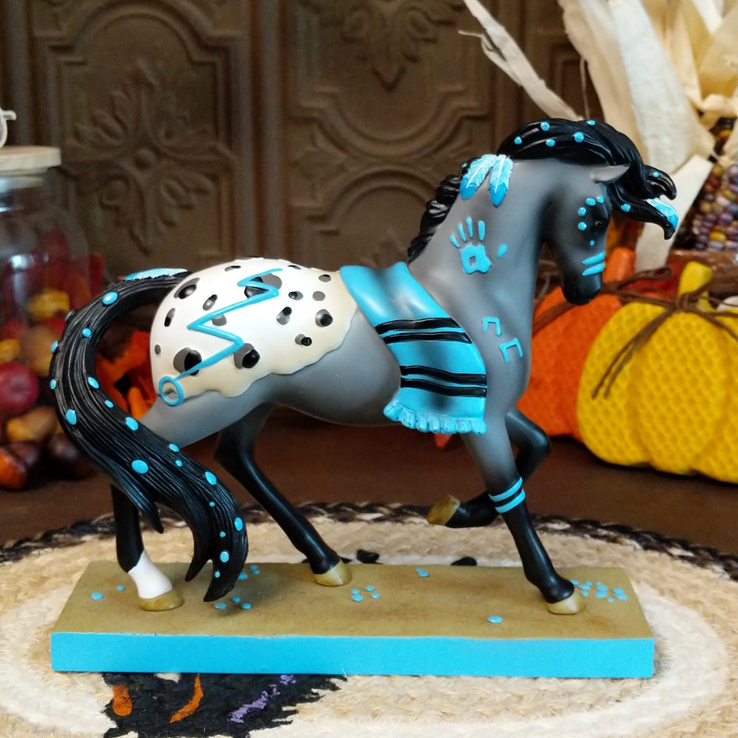Resin gray appaloosa pony painted with turquoise Native American motifs along the body.