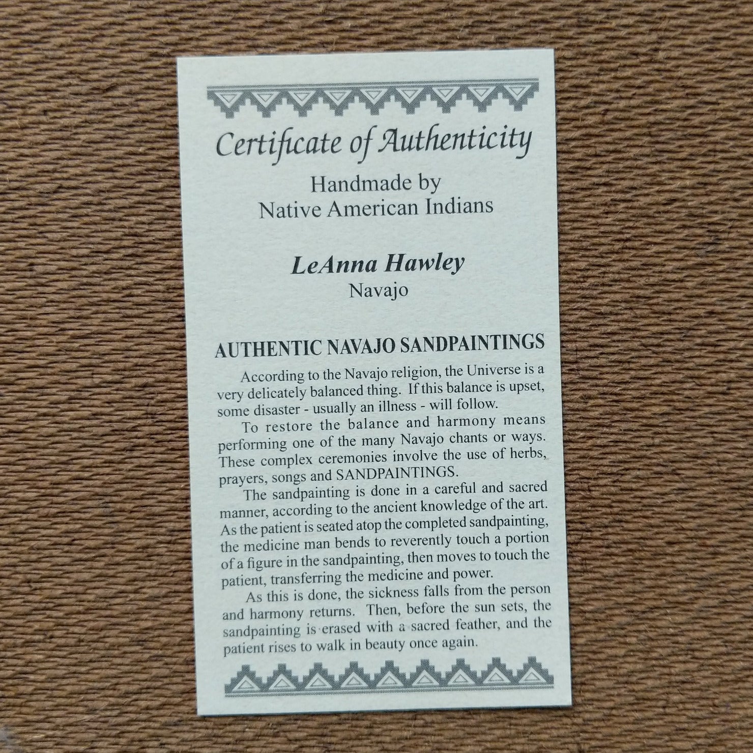 Close up of the Certificate of Authenticity and Artist information.