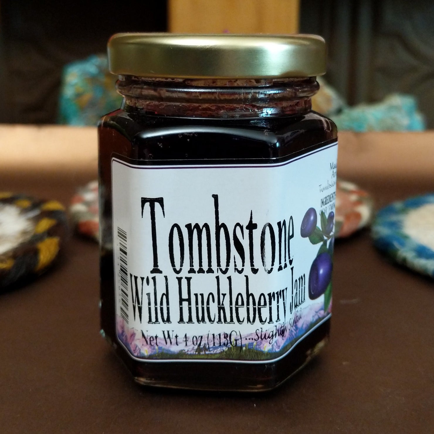 Jar of Tombstone Wild Huckleberry Jam on a table.