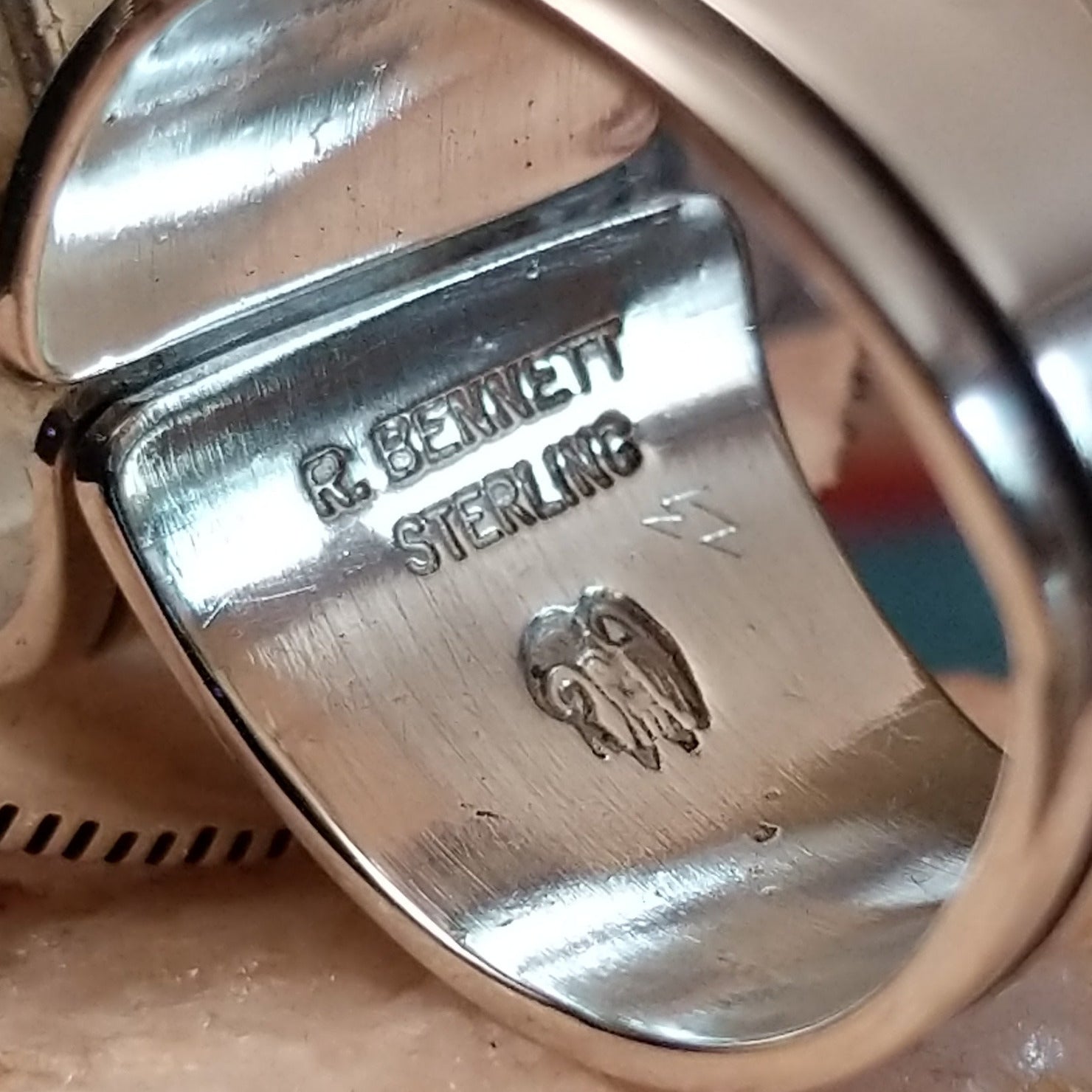 Close-up of the artist's stamped signature.