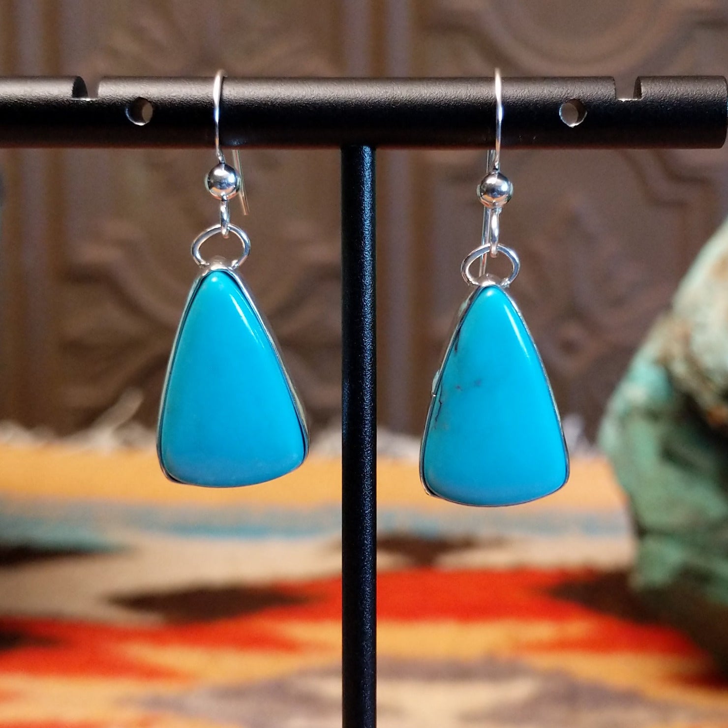 Triangular sterling silver dangle earrings with Kingman turquoise set in the bezels.
