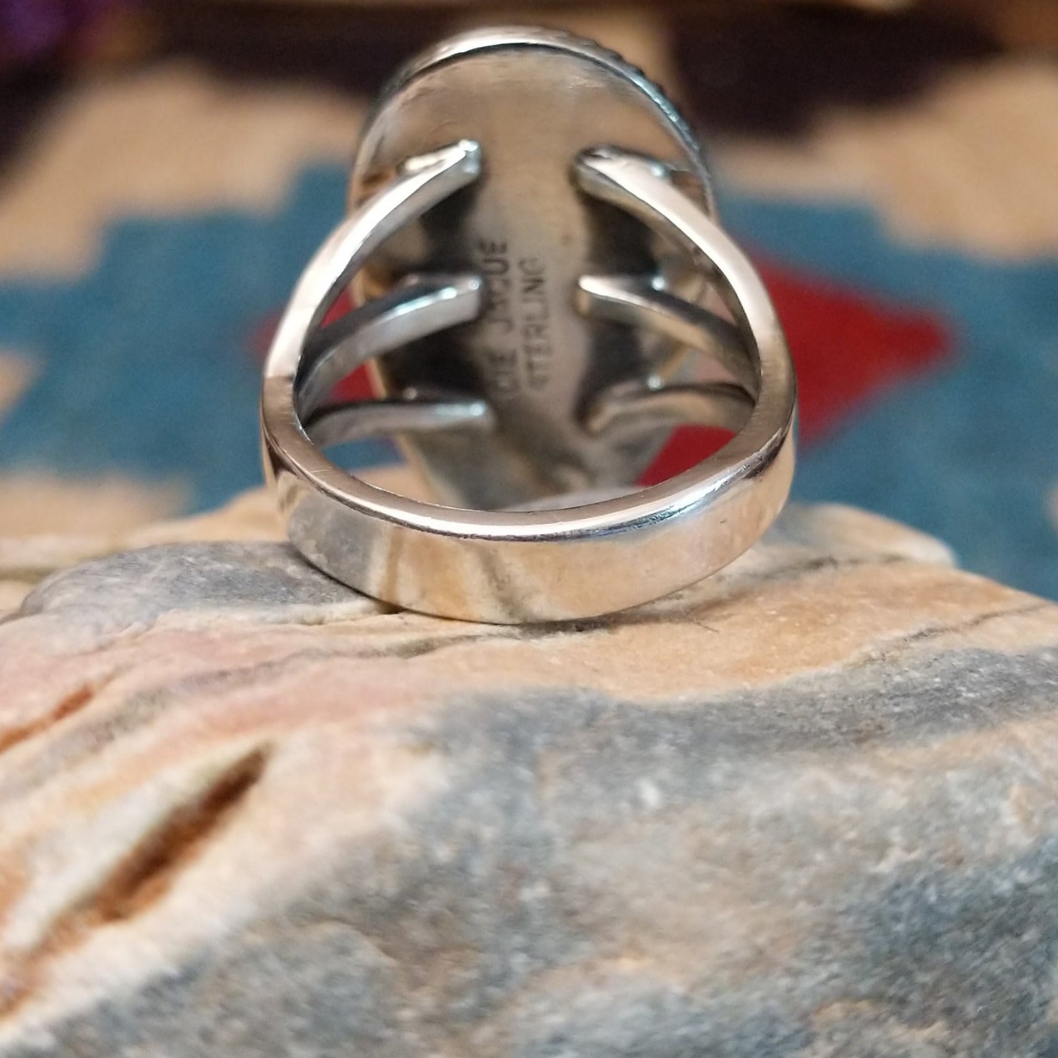 Sterling silver ring with Sonoran gold turquoise set in the bezel, framed by coiled accents.
