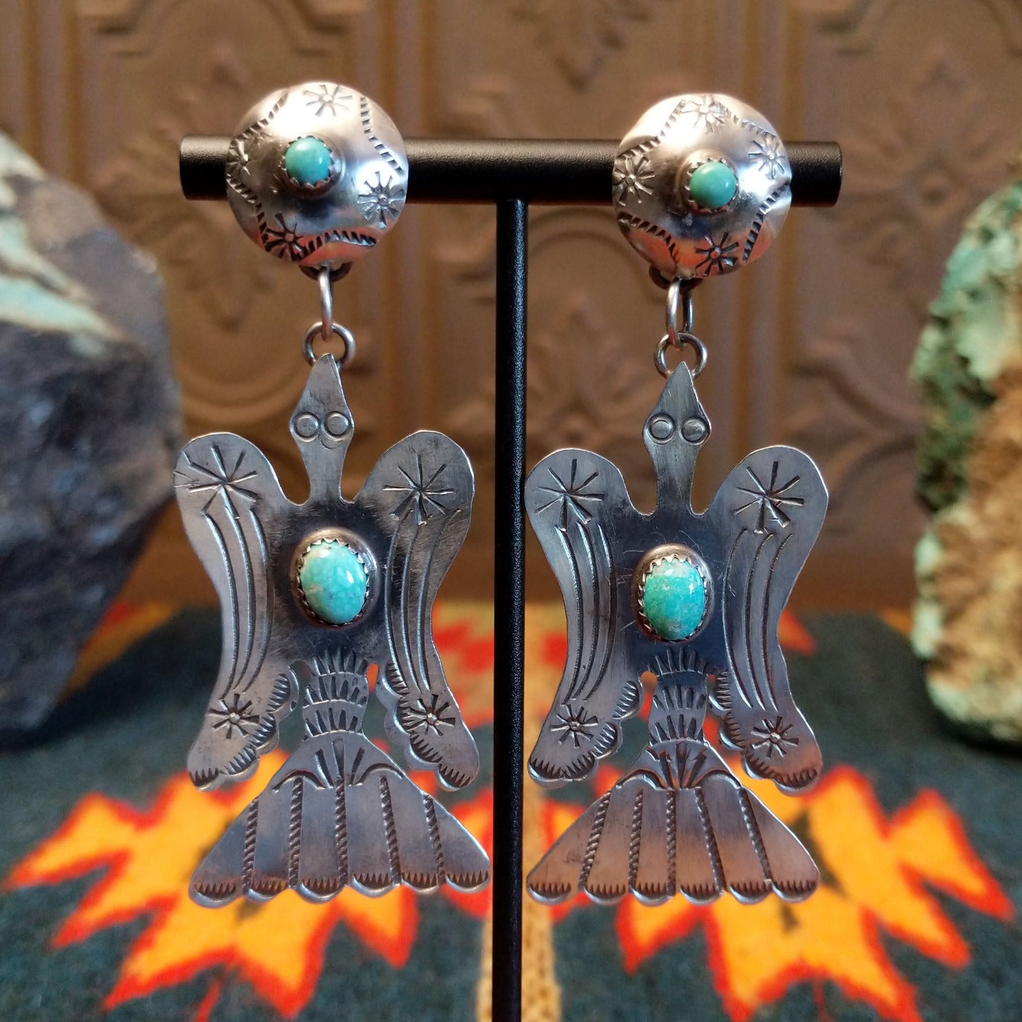 Sterling silver bird earrings with turquoise set in the notched bezel as the centerpiece.