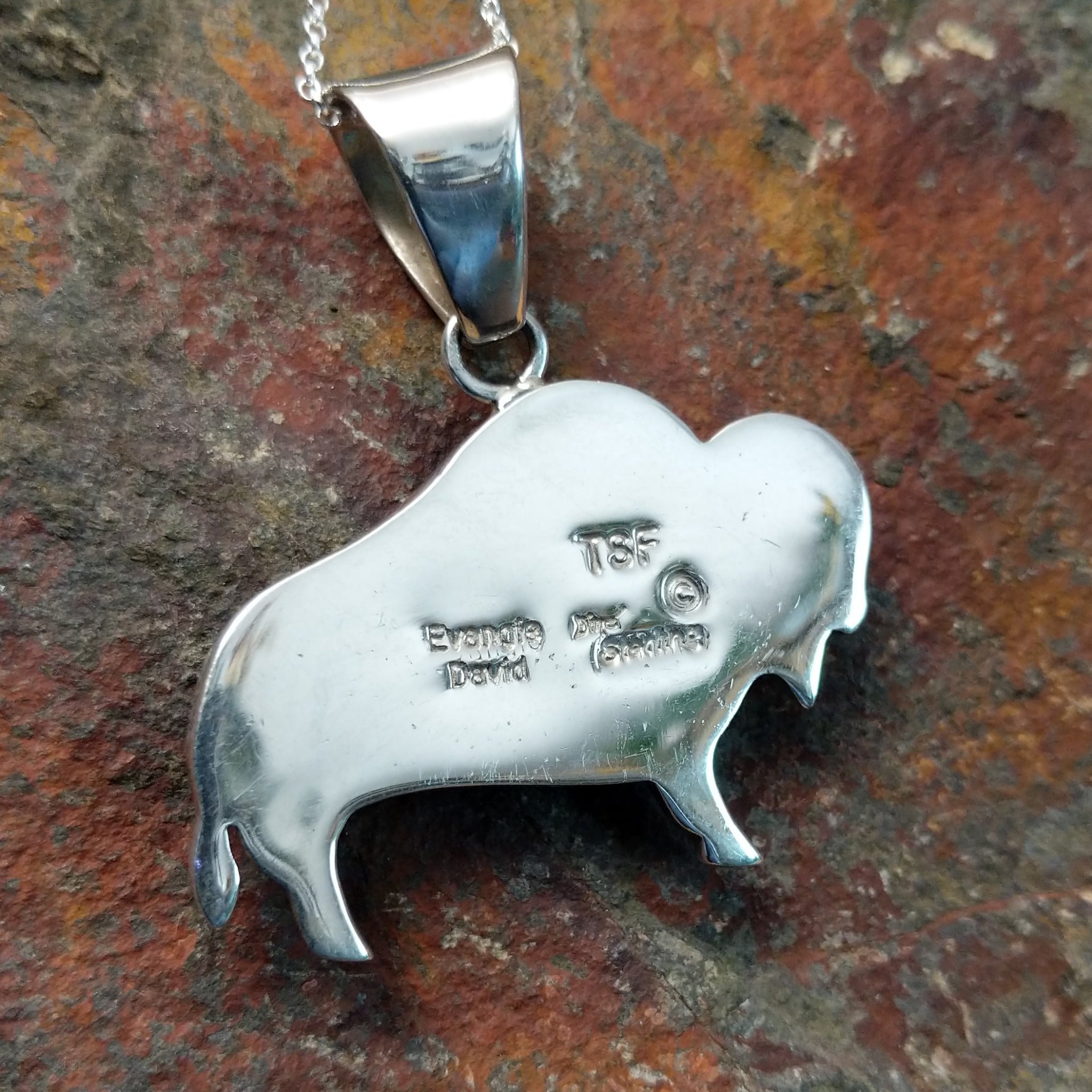Handcrafted sterling silver turquoise buffalo inlay pendant by Evangie David, featuring a traditional buffalo design; artisan and Sterling Silver stamp.