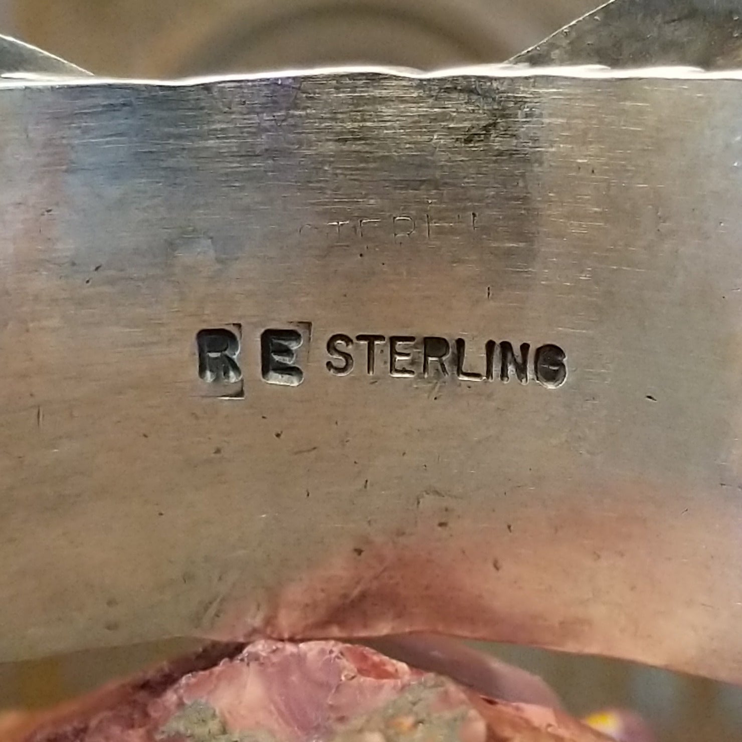 Close-up of the artisan's stamped signature.