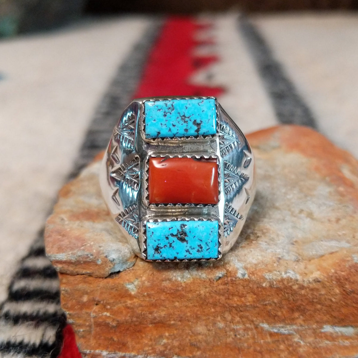 Turquoise and coral silver ring by Pauline Nelson with stamped arrow designs.