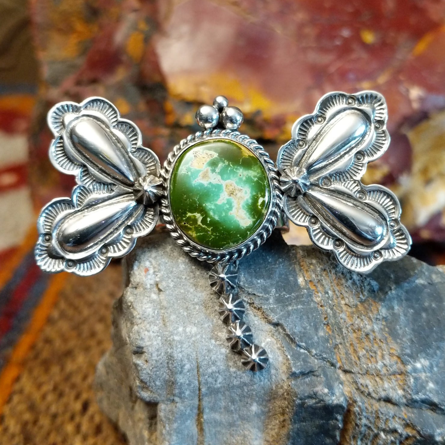 Sterling silver dragonfly pendant with twisted rope detailing and turquoise set in the bezel.