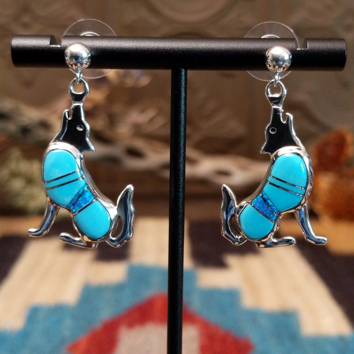 Sterling silver coyote earrings with turquoise set in the bezels.