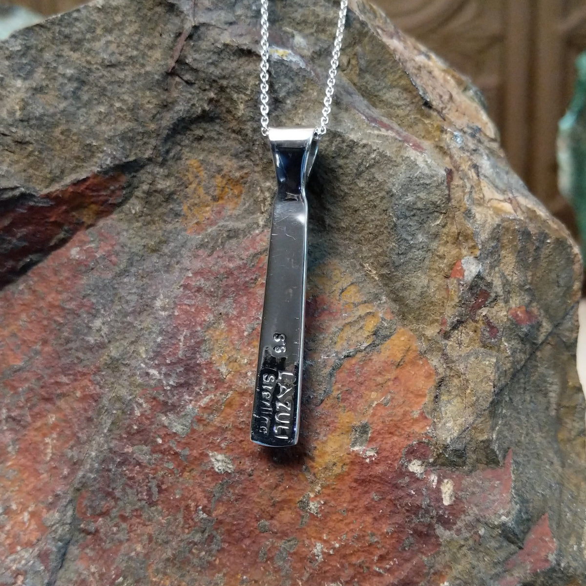 Turquoise inlay pendant by Stacy Spencer featuring an elongated geometric design with vibrant turquoise sections set in polished sterling silver and a turquoise-inlaid bail; artisan and Sterling Silver stamp.